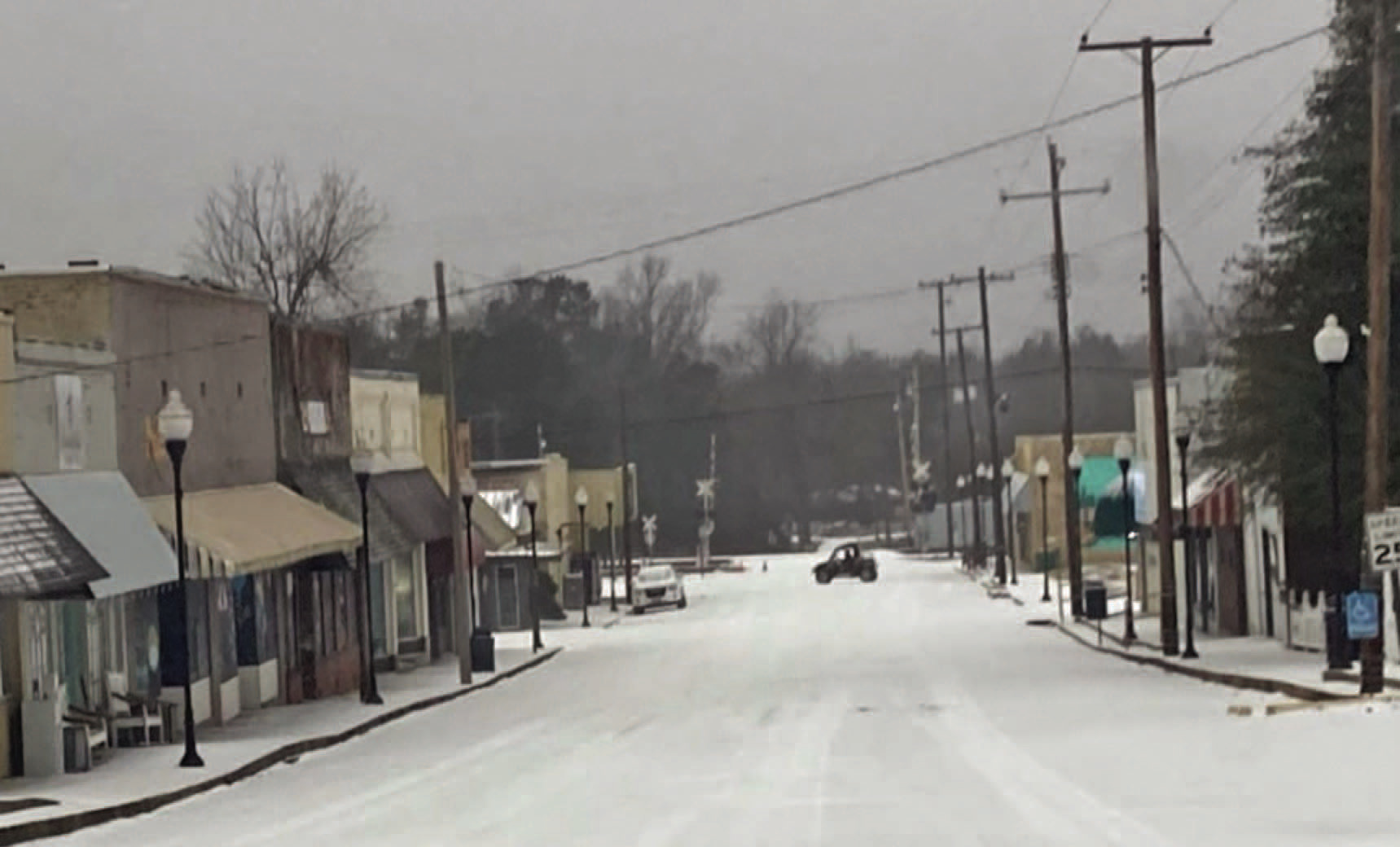 SLOW DAY ON MAIN STREET -  A side-by-side makes a U-turn on an otherwise desolate Main Street in downtown Rison Monday morning. With schools, government offices and banks closed for the Martin Luther King holiday, very few motorist ventured out onto the icy roads.