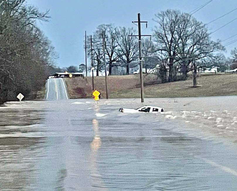 MOTORIST RESCUED - Arkansas Game &amp; Fish Officer Eric Rawls of Rison conducted a boat rescue of a the driver of this pickup truck that was washed off Hwy. 114 just east of the Cleveland-Lincoln County line at Hudgin Creek early Tuesday morning. This was the third rescue of motorists at this same location on Hwy. 114 in the past few years. (Photo courtesy of Eric Rawls)