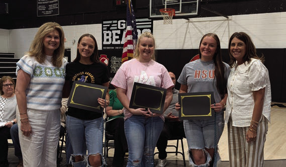 Jenny Saterlee (far left) and Stephanie Hollis (far right) present the AmeriCorps Scholarship to Jailyn Wright, Jaimie Simmons, and Karsyn Chastain