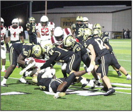 GANG TACKLE - Rison's Kyson Waker (3, bottom) wraps up Fordyce running back Tramane Turner near the line of scrimmage as teammates Javis McGhee (69), Tanner Collins (64), Galvin Wilson, Jr. (54) and Dalton Lee (12) close in to assist. The Wildcats had one of their better defensive performances, holding the Redbugs to 257 yards rushing for the game, 78 of which came on one play. (Photo by Chris Phillips)