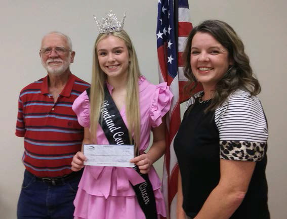 CLEVELAND COUNTY FAIR PRINCESS - Fair Princess Cain Wilkins (center) is presented a check from Amber Offutt of Gateway Bank (right) and Fair President Roy Phillips (left) during the Cleveland County Fair Board meeting held last week.