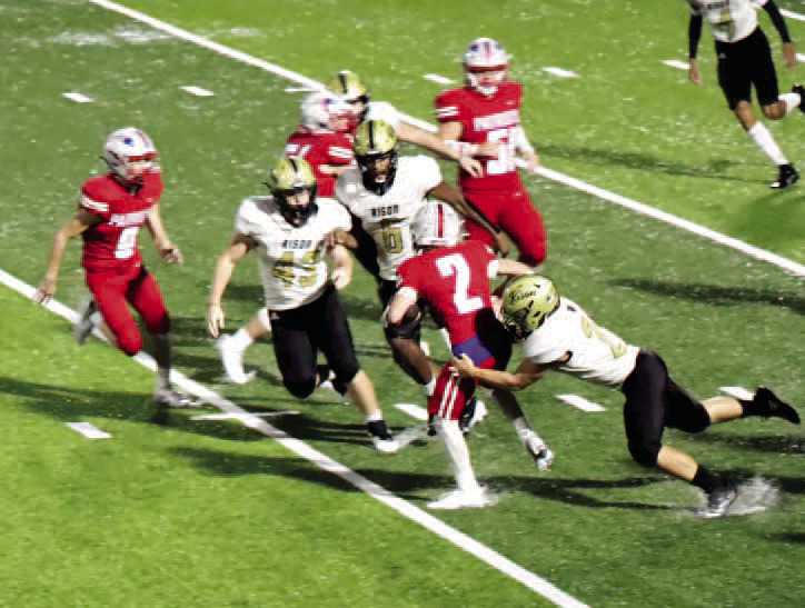 NO WHERE TO GO - Palestine-Wheatley's Easton Vaccaro (no. 2) fin ds himself trapped as Rison's Aaron Tilley (right, no. 21) moves in for the tackle while teammates Bryce Phillips (no. 43) and Jaquis Rauls (no. 6) close in on the play. The Wildcats defense held the Patriots to just two first downs in the game. (Photo by Chris Phillips)