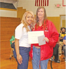 Jenny Wright (right) presents the Dakota Wright Memorial Scholarship to Rison High School Senior India Ballard (left).