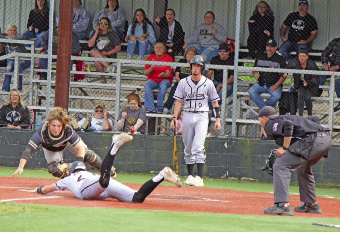 CRUCIAL PLAY AT THE PLATE - Rison catcher James Jacobs lunges toward home plate to make a play on Woodlawn's Austin Howard as he attempts to steal home in the top of the fourth inning. Howard made his move as the Wildcats made a throw to first, but an alert Rison first baseman Jared Saeler made the throw back home to get the call for the third out. Woodlawn's Dylan Butler is in the background. Howard's run would have given the Bears the lead after Tate Hall had driven in the tying run to make it 2-2.