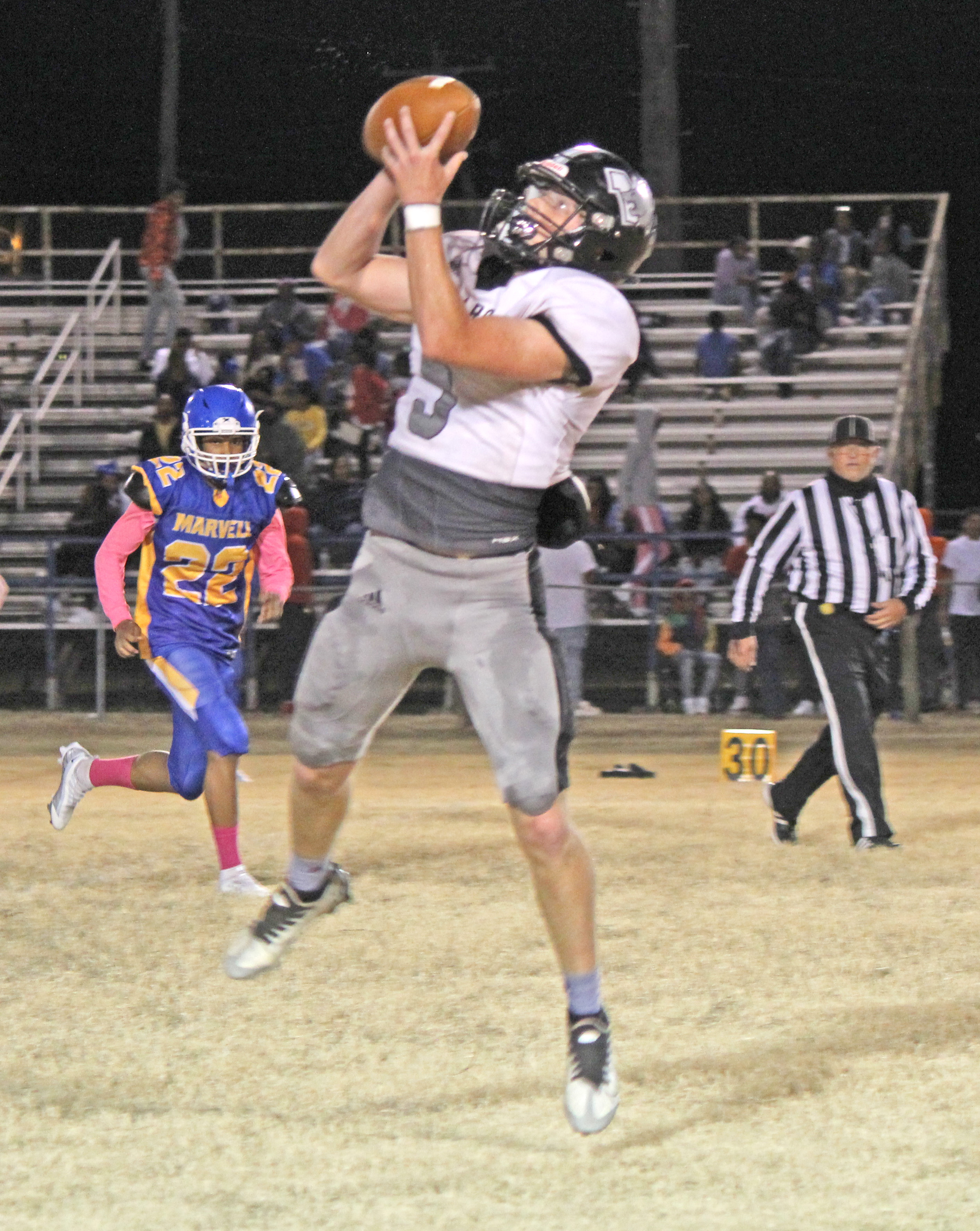 AIR BEARS - Woodlawn’s Payton Leveritt pulls down an 18-yard pass from Jaxson Martin during second quarter action Friday night at Marvell. The Bears, who usually rely on their run game, saw some success through the air against the Mustangs as Martin completed 7-of-10 pass attempts for 121 yards.
