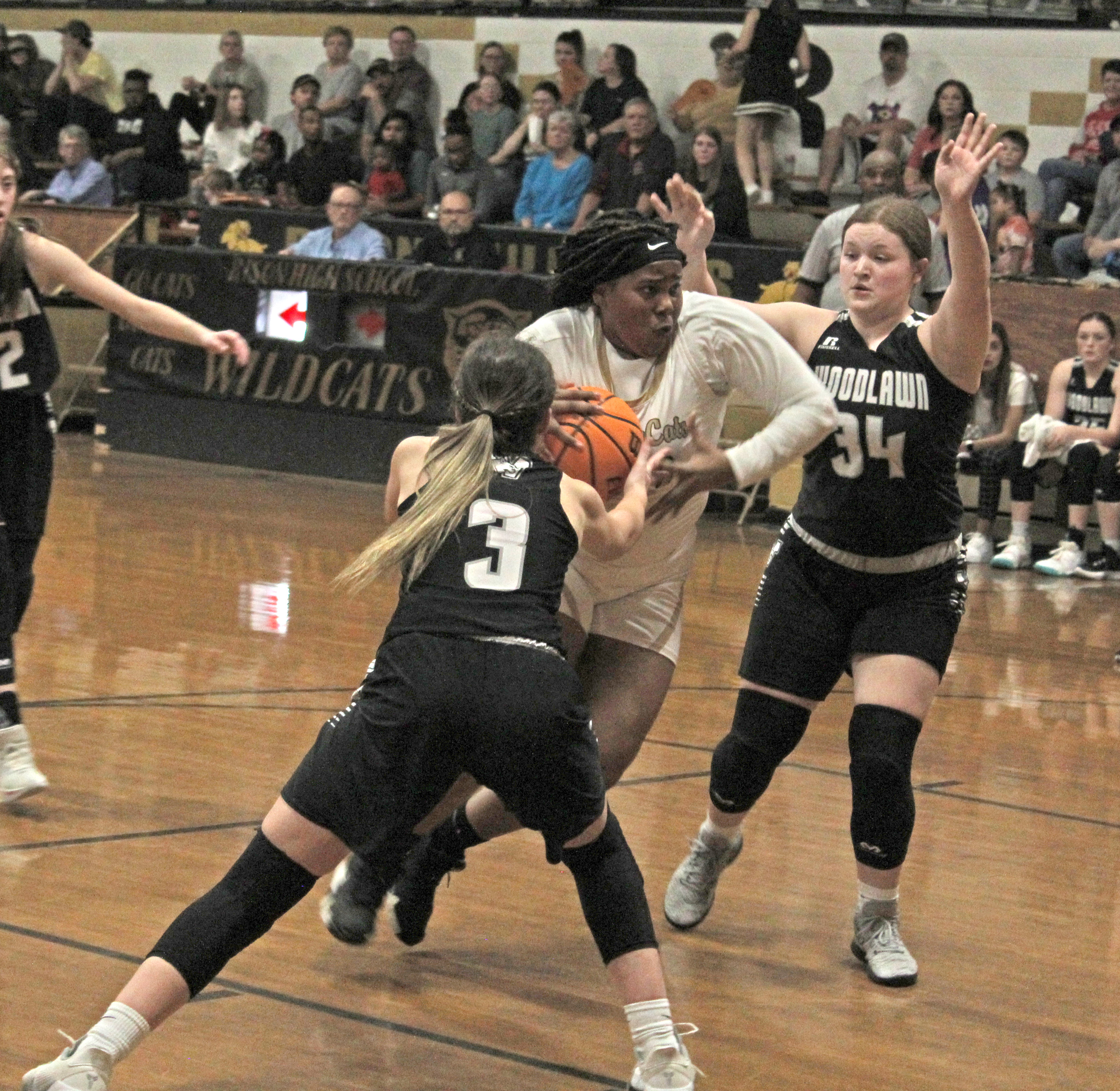 DRIVING THE LANE - Rison’s Shermyah Bracey drives the lane against Woodlawn’s Anna Fitzgibbon (nol. 3) and Skylar Conner (no. 34) in first half action of Tuesday’s battle of Cleveland County rivals.