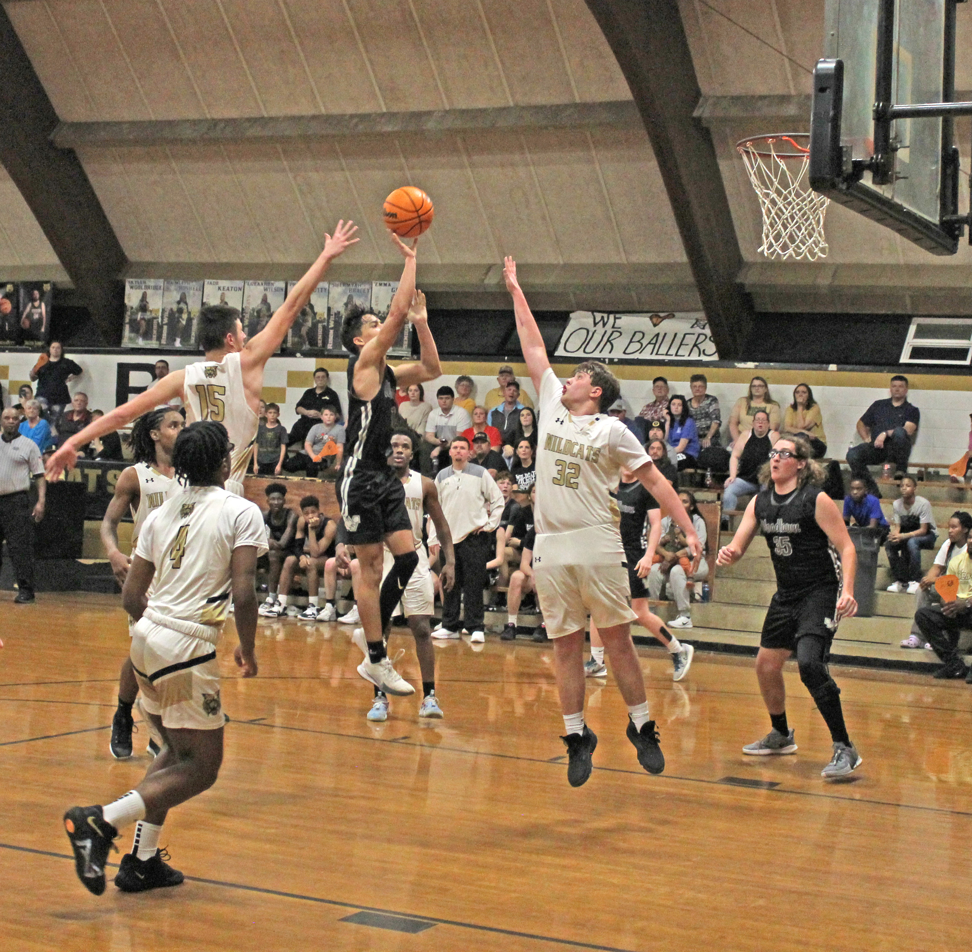 BEARS TURN BACK WILDCATS - Woodlawn’s Jaxson Martin (center) delivers a floater over Rison defenders Owen Morrison (no. 15) and Thomas Wilson (no. 32) late in the fourth quarter as the Bears held on for a 77-70 victory over the Wildcats in a renewal of the Cleveland County rivalry Tuesday night at the Rison Gym.