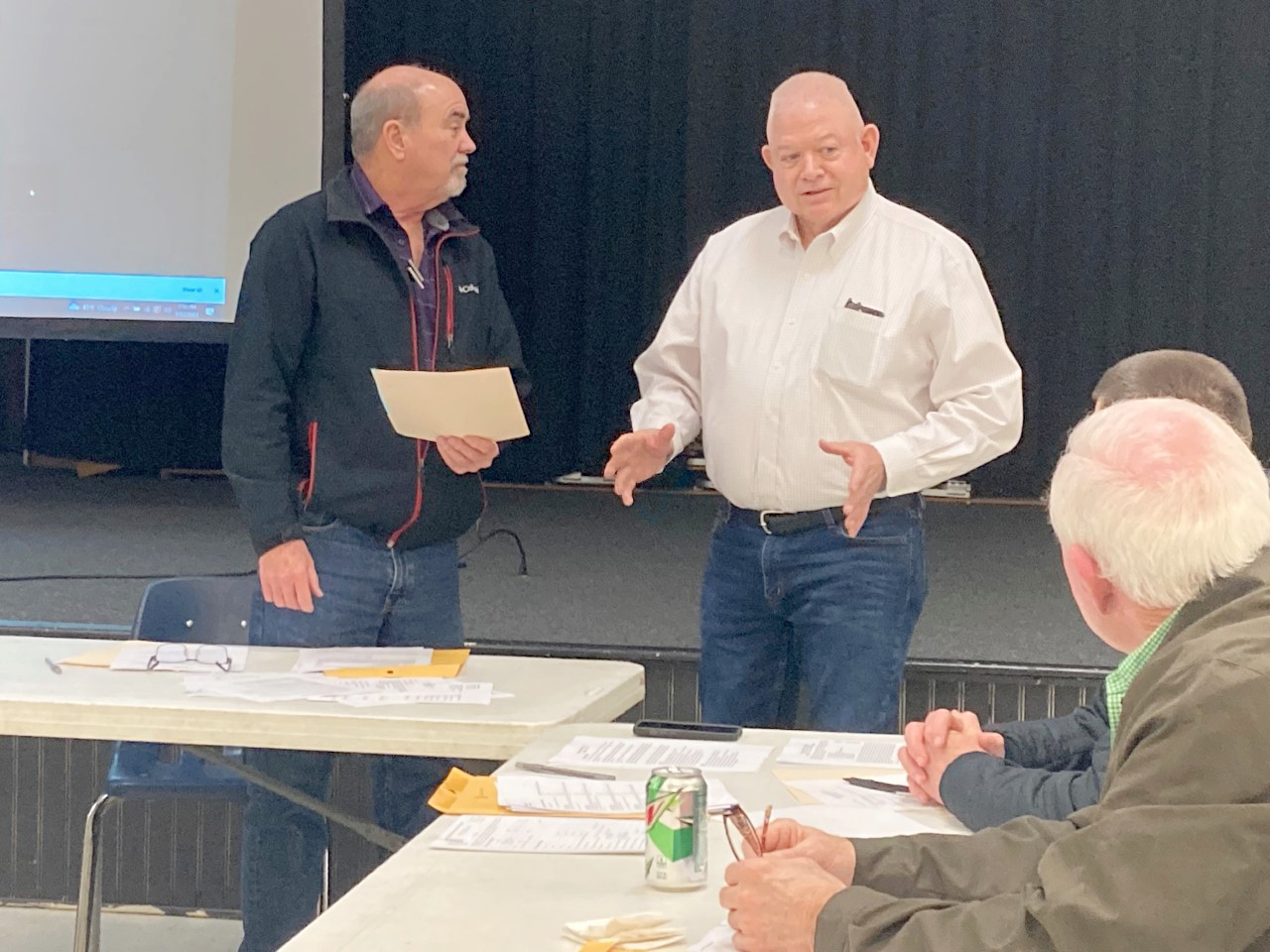 Woodlawn School Board President Larry Reynolds (left) listens to County Judge Jimmy Cummings (center) as he addresses the board after presenting them with a proclamation that honors local school boards during School Board Appreciation month. Also listening Woodlawn School Board memberts David Stover (foreground) and Shane Dixon (background).