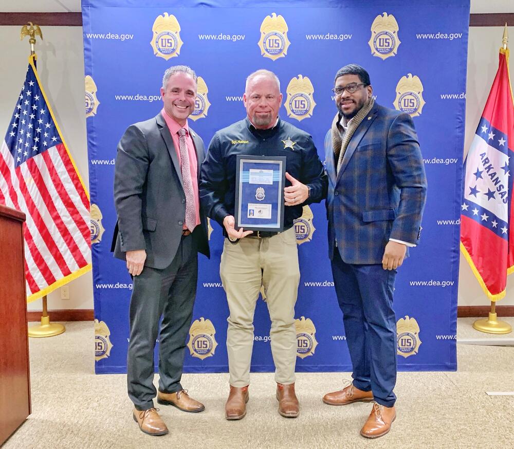 Jefferson County Sheriff's Sergeant Jimmy F. "Bo" Hudson, Jr. (center), was presented his DEA credentials during a brief ceremony at the Drug Enforcement Administration Little Rock District Office (DEA-LRDO). Making the presentation was Jared Harper (left), Assistant Special Agent in Charge of the DEA in Arkansas, and Sheriff Lafayette Woods, Jr. (right).