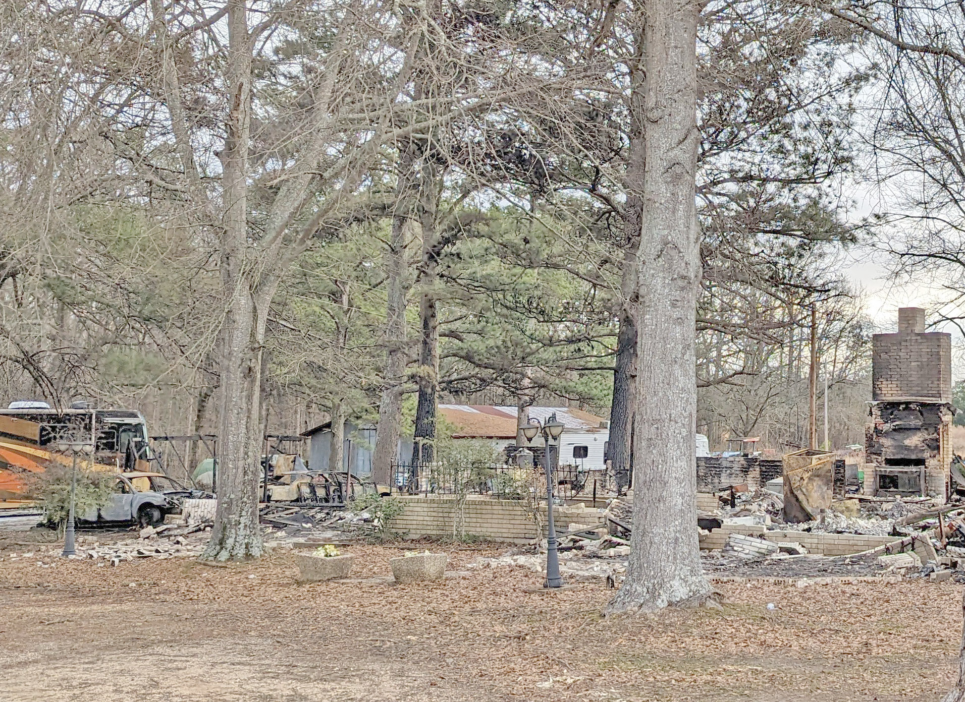 FIRE DESTROYS HOME NEAR WOODLAWN - A fire that may have been started by a car parked in the garage (far left of photo) destroyed this home at 3790 Hwy. 63 north of Woodlawn early Friday afternoon. Woodlawn Fire Chief Owen Rushing said the car was in flames inside the garage area when firefighters arrived and it spread into the attic area of the adjoining house.