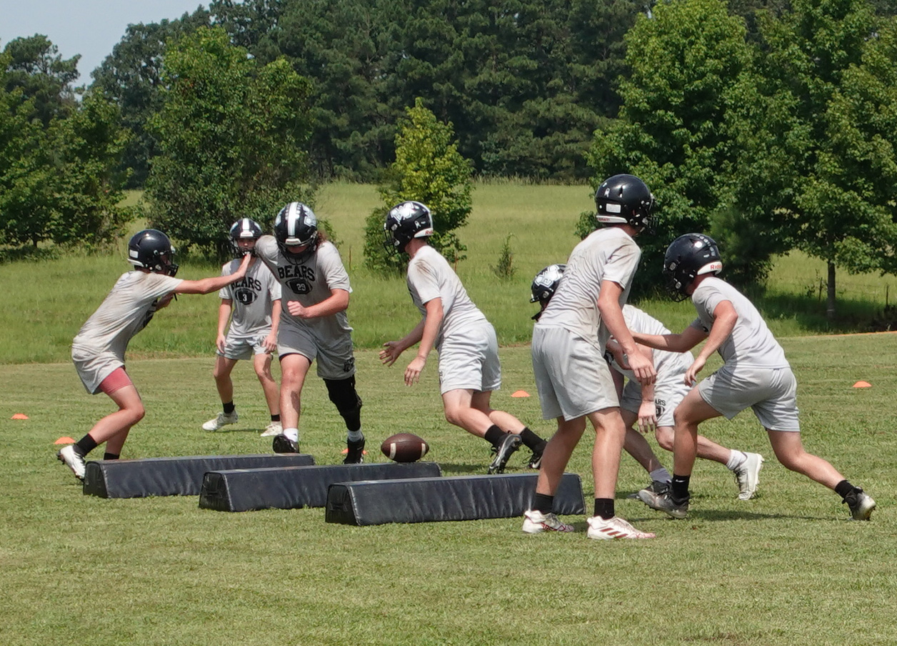The Woodlawn Bears' defensive line executes a play during their second day of preseason drills on the practice field behind the Carl Jones Sports Complex. Woodlawn is coming off a 9-2 season where the Bears advanced to the Class 2A eight-man state semifinals before falling at Izard County, 62-56, on the last play of the game. Izard County went on to win the state title.