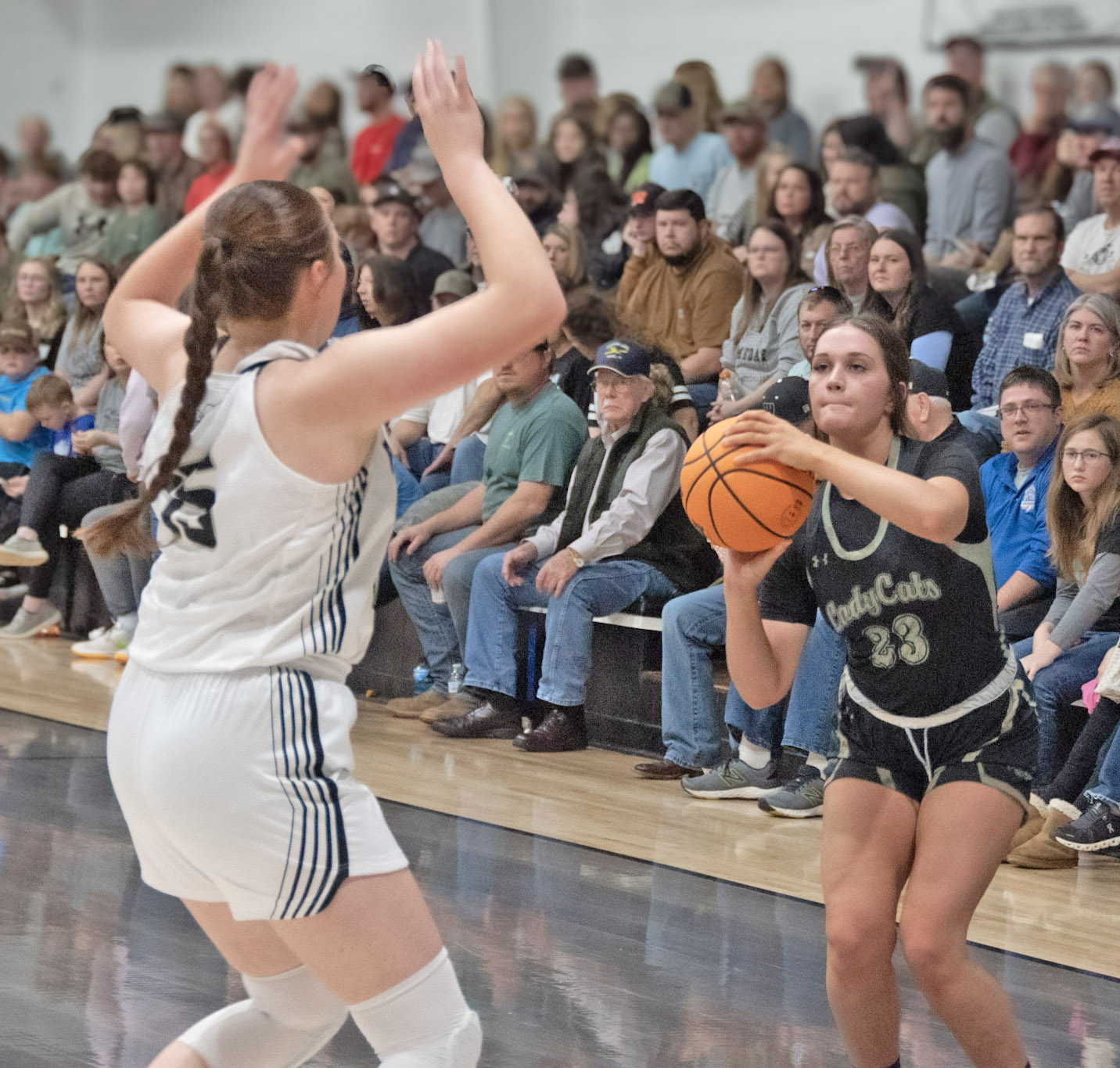 POTTER FUELS LADY ‘CATS - Rison junior Layne Potter (right) prepares to launch a jumper over Woodlawn’s Lillie Faye McWhorter (left) during last Thursday’s game between the county rivals inside a packed Woodlawn gym. Potter had one of her best games of the year, leading all scorers with 20 points. (Photo by Kelvin Scott/Cardboard Sports)