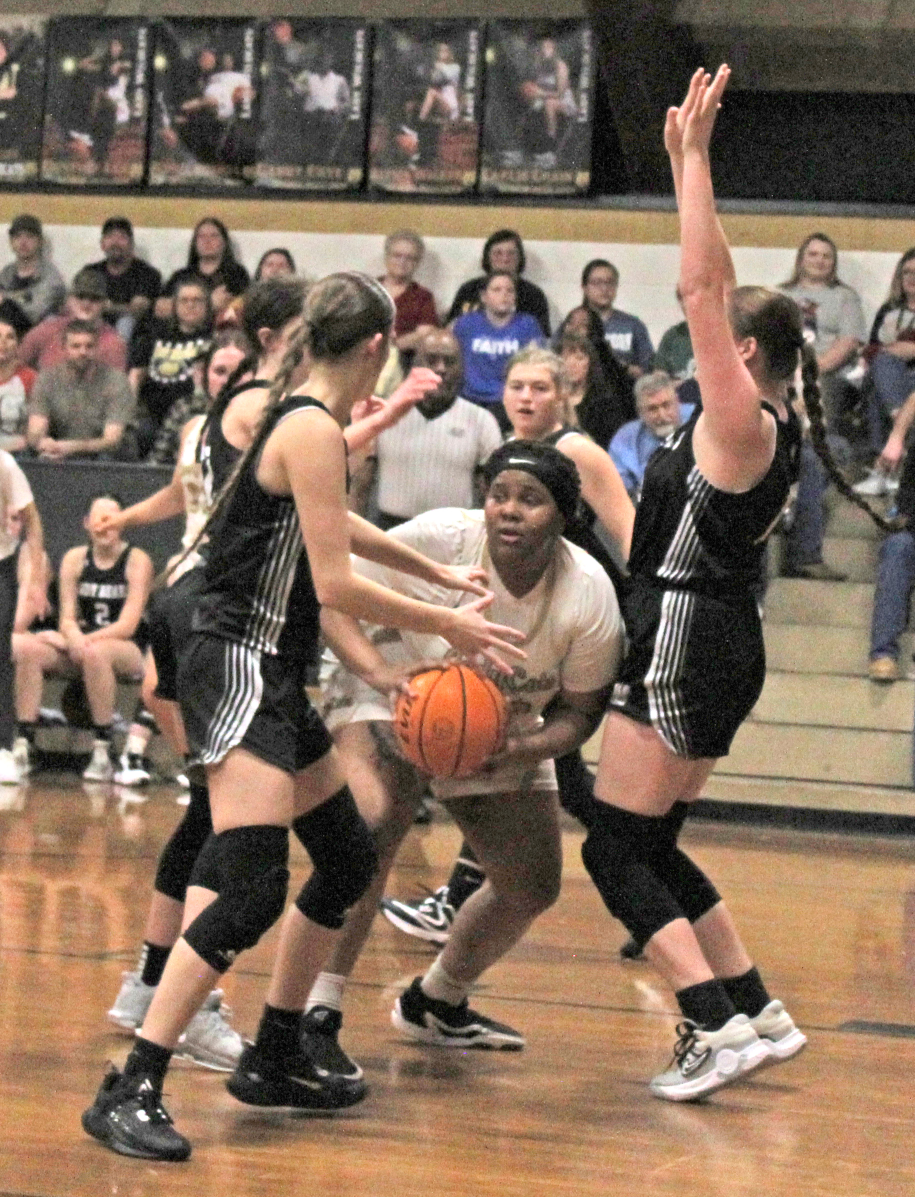 TOUGH INSIDE - Rison’s R’erel Roshell (center) looks for relief as she is finds herself surrounded by Woodlawn’s Kathryn Dixon (left) and Lillie Faye McWhorter (right) in last Friday’s battle between the Cleveland County rivals. The Lady Bears saw their 19-point second half lead cut to three in the fourth quarter before holding on for the 45-41 win.