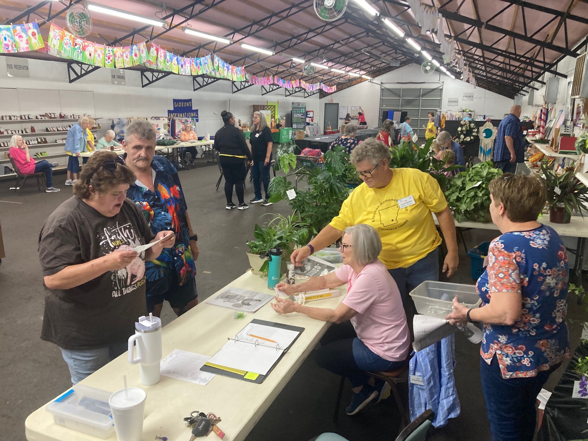 CHECK-IN DAY AT THE CLEVELAND COUNTY FAIR - Superintendents Kathy Waldrop, Marty Bowlin and Patricia McClellan (pictured on the right) are busy Tuesday afternoon checking in plants that will be among the being judged during the 2024 Cleveland County Fair that week at the fairgrounds in Rison. Cleveland County Fair Board President Roy Phillips said they expect to have more than 100 entries in this year's fair after livestock and baked goods are checked in today.