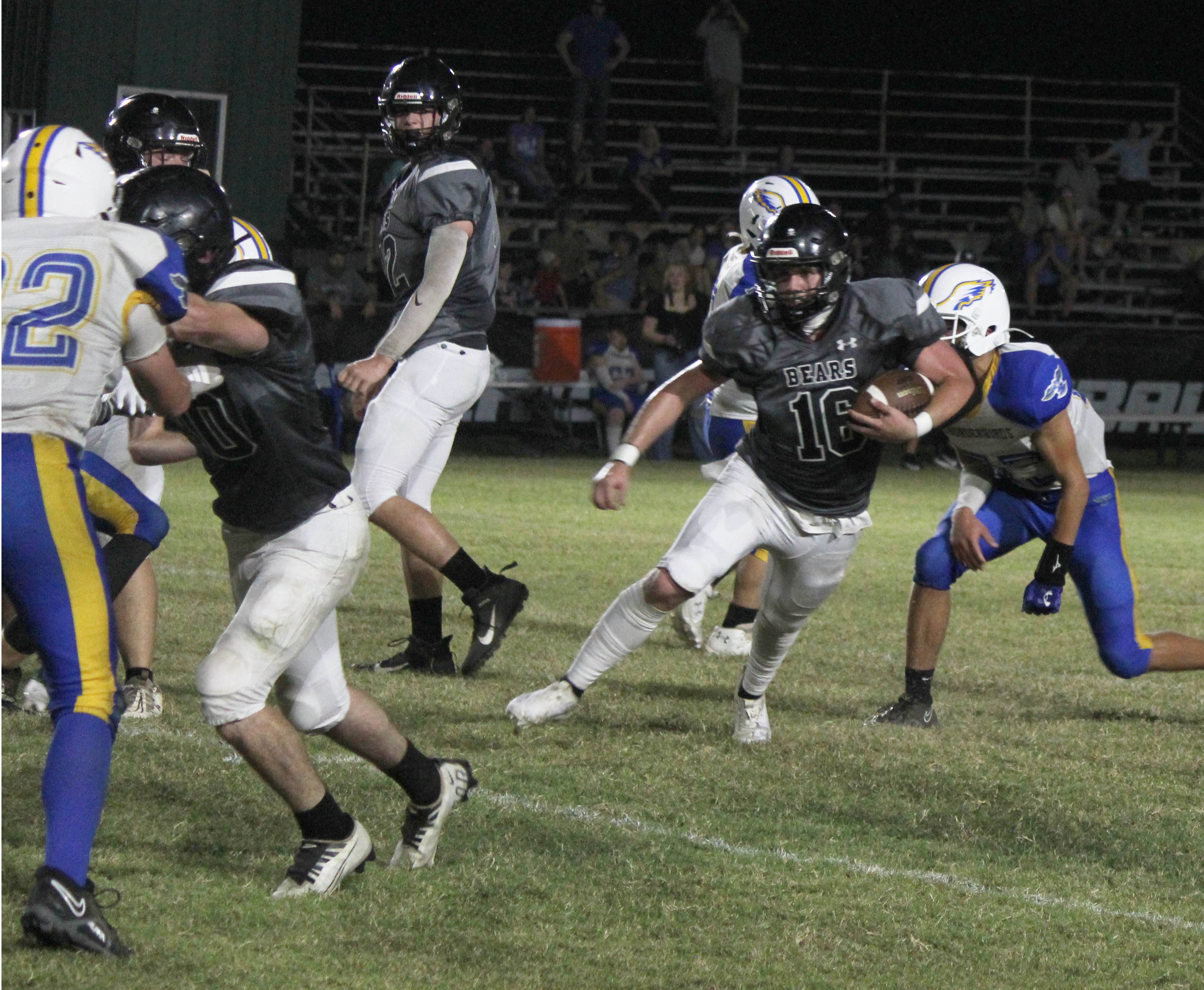 OLIVER TAKES IT TO THE HOUSE - Woodlawn senior fullback Ethan Oliver (no. 16, right) looks to the outside behind the block of junior tight end Matthew Green (left, no. 40) before going 28 yards for the touchdown for his only carry of the game. The Bears rushed the ball just seven times with four of those scoring for scores before Guy-Perkins decided to end the game before the halfway mark of the second quarter. Also pictured for Woodlawn is lineman Landan Johnson (center of photo).