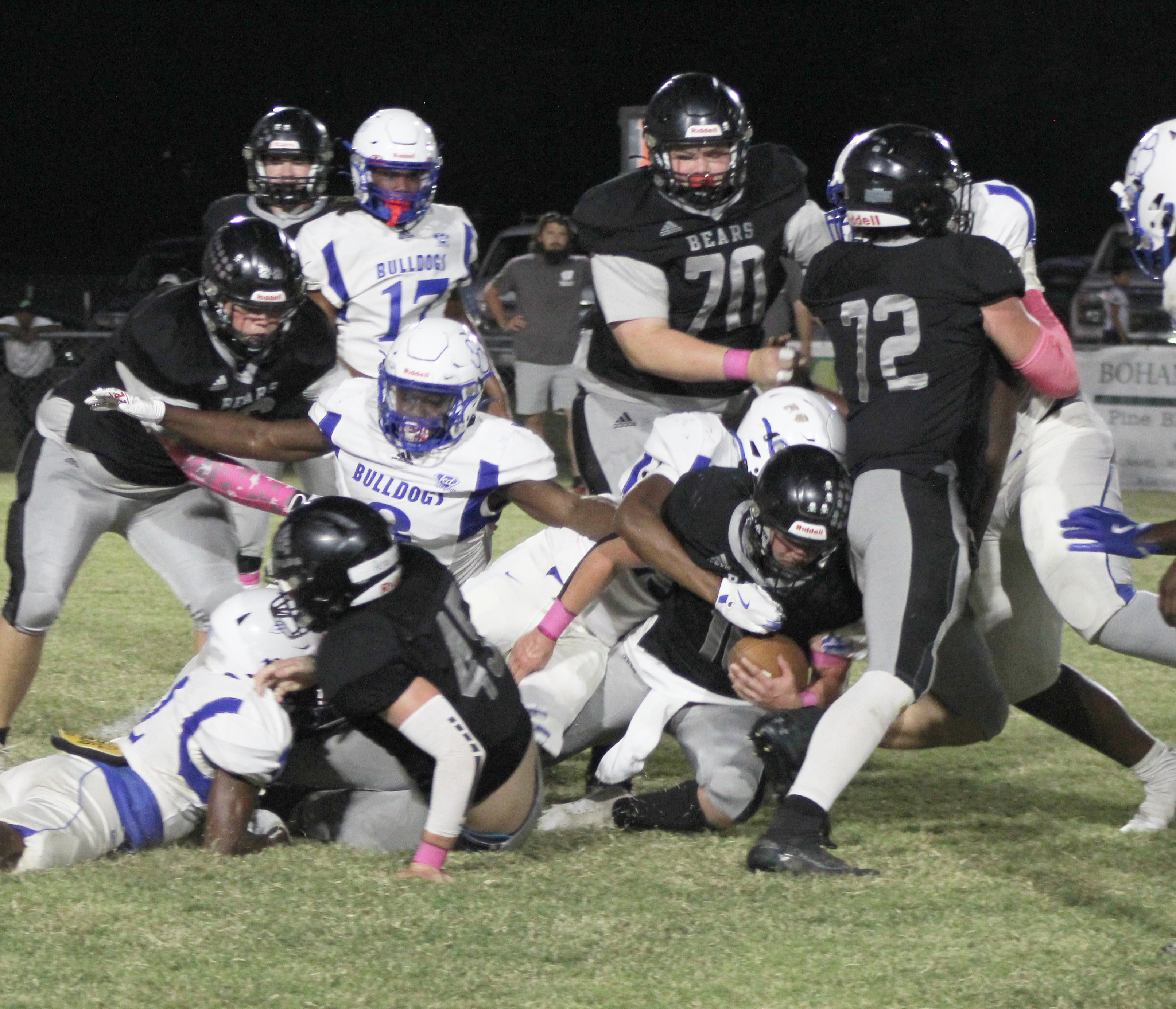 TOUGH RUNNING - Woodlawn senior fullback Ethan Oliver (center) fights for yardage against a big and fast Strong defense in first half action Friday night. Oliver ended up leading Woodlawn in rushing with 55 yards on 13 carries after the Bulldogs came after the Bears’ leading rusher, Garrett Weatherford. Also pictured for the Bears are (left to right) Dakota Campbell (66), Beau Watson (45), Aiden Powell (70) and Landan Johnson (72).