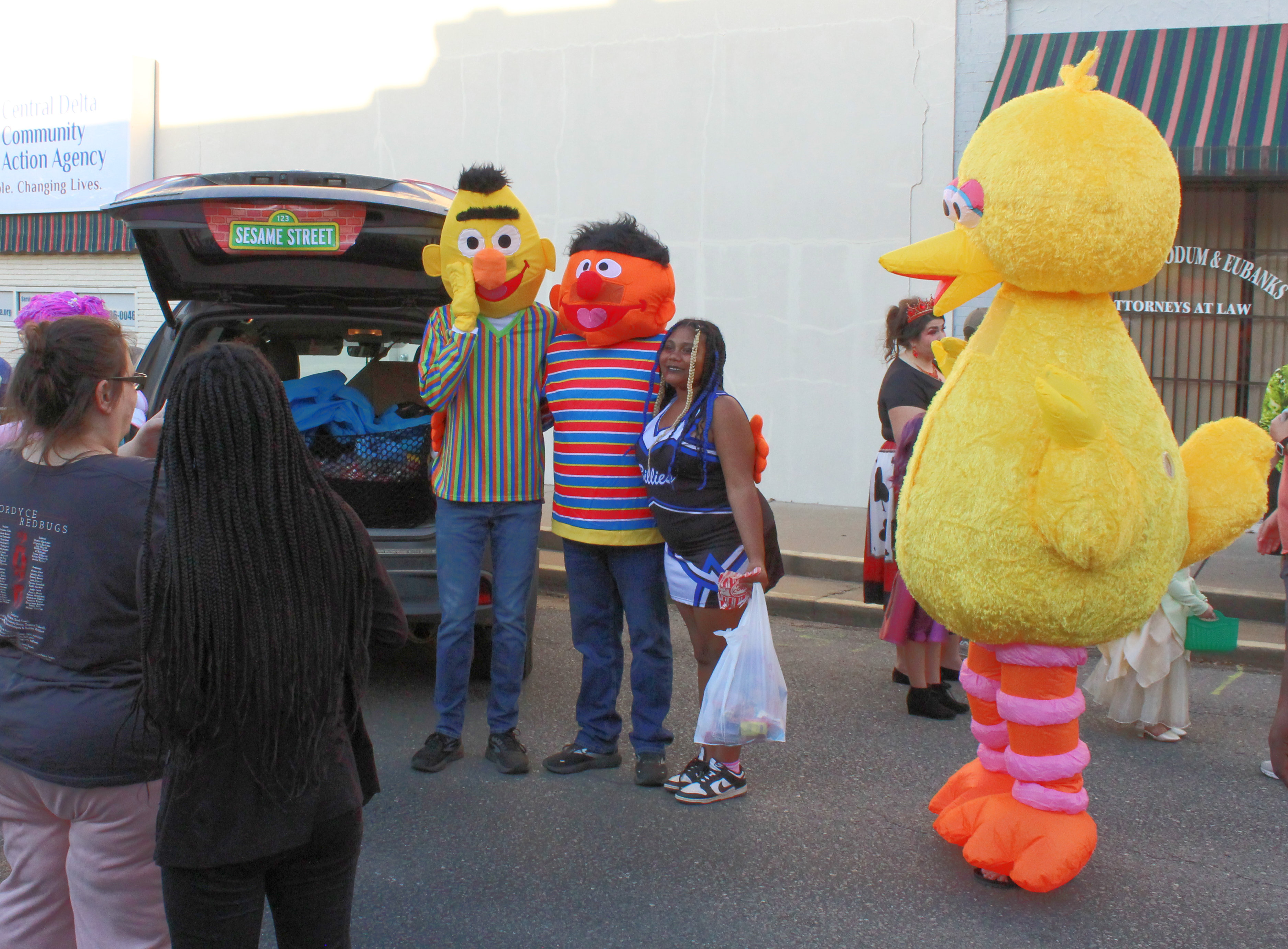 RISON SHINE TRUNK-OR-TREAT - A trunk-or-treater poses with characters form Sesame Street that were one of the “trunkers” at the Rison Shine Trunk-or-Treat held along the 200 block of Main Street in downtown Rison. An estimated 1,000 people took part in the event. While usually held on Halloween night, Trunk-or-Treat was moved to Tuesday night due to the Rison-Fordyce junior high football game being held Thursday night.