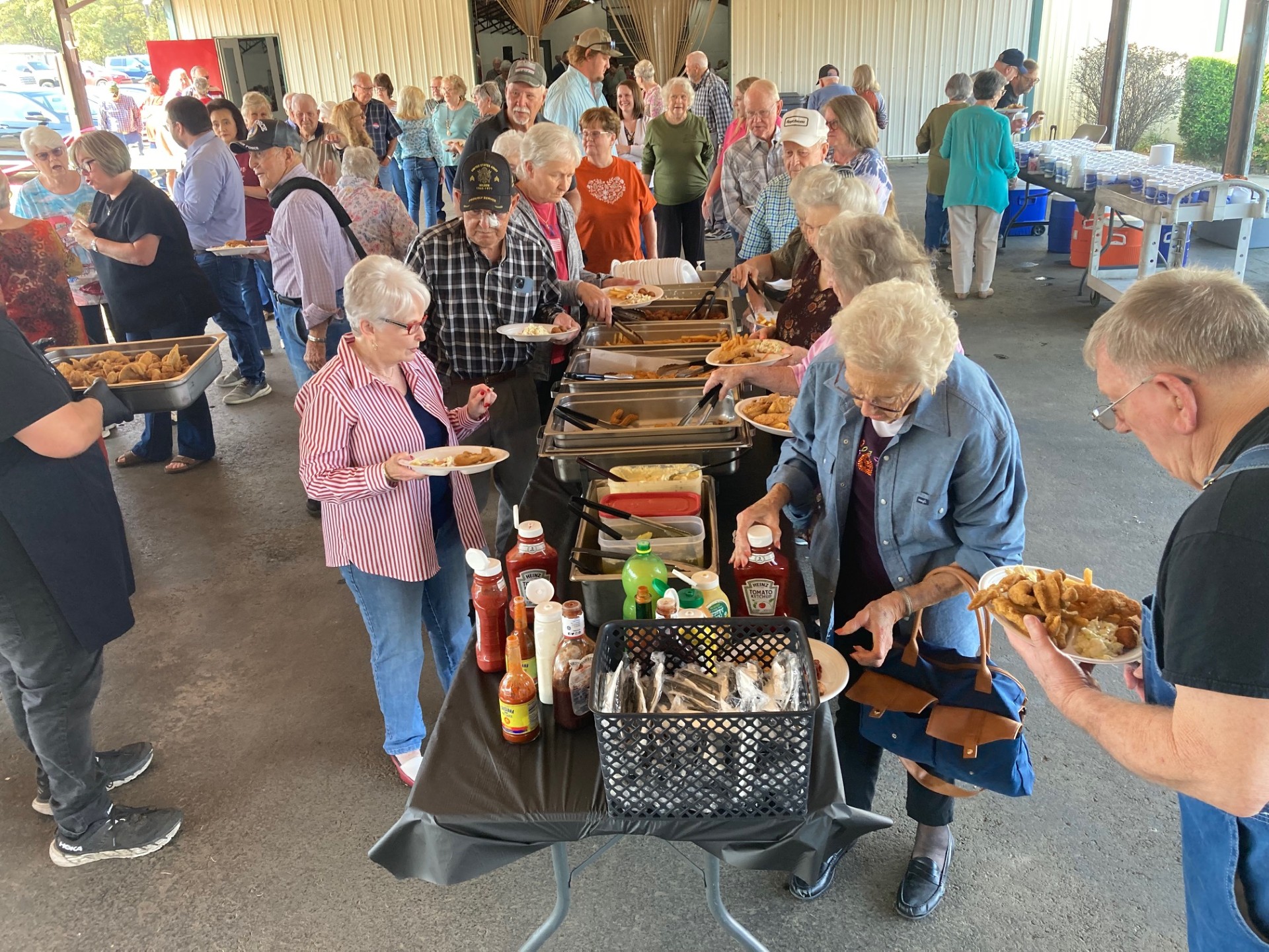 CHOW LINE - Veterans and their guests along with other attendees go through the serving line at the Cleveland County Veterans Appreciation Dinner held Saturday at the fairgrounds in Rison. All veterans and a guest enjoyed a catfish and chicken buffet prepared by Dorey’s Catfish. This year was the 10th anniversary of the dinner.