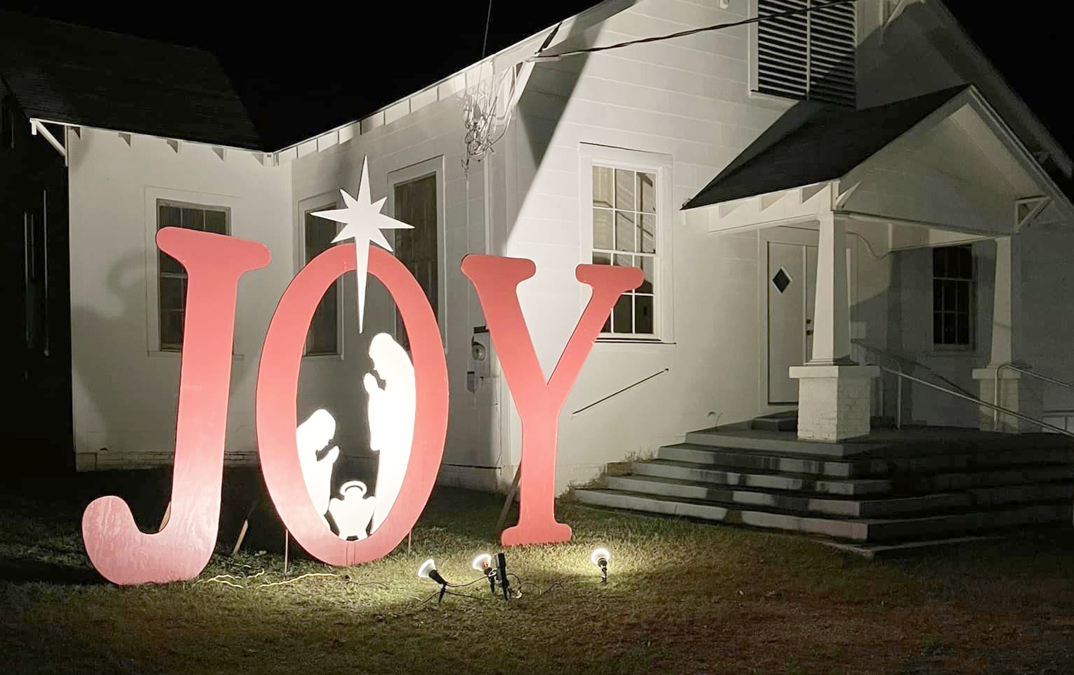 A large, lighted JOY sign greets visitors as they pass by  First Baptist Church of New Edinburg. 
