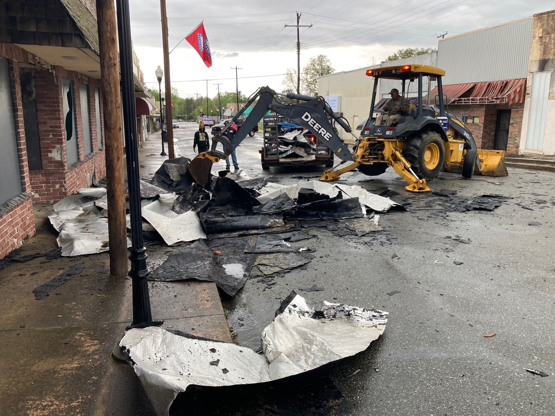 The City of Rison street crew works to remove pieces of the roof from the former Cash’s AG Grocery Store from the 200 block of Main Street Thursday afternoon.