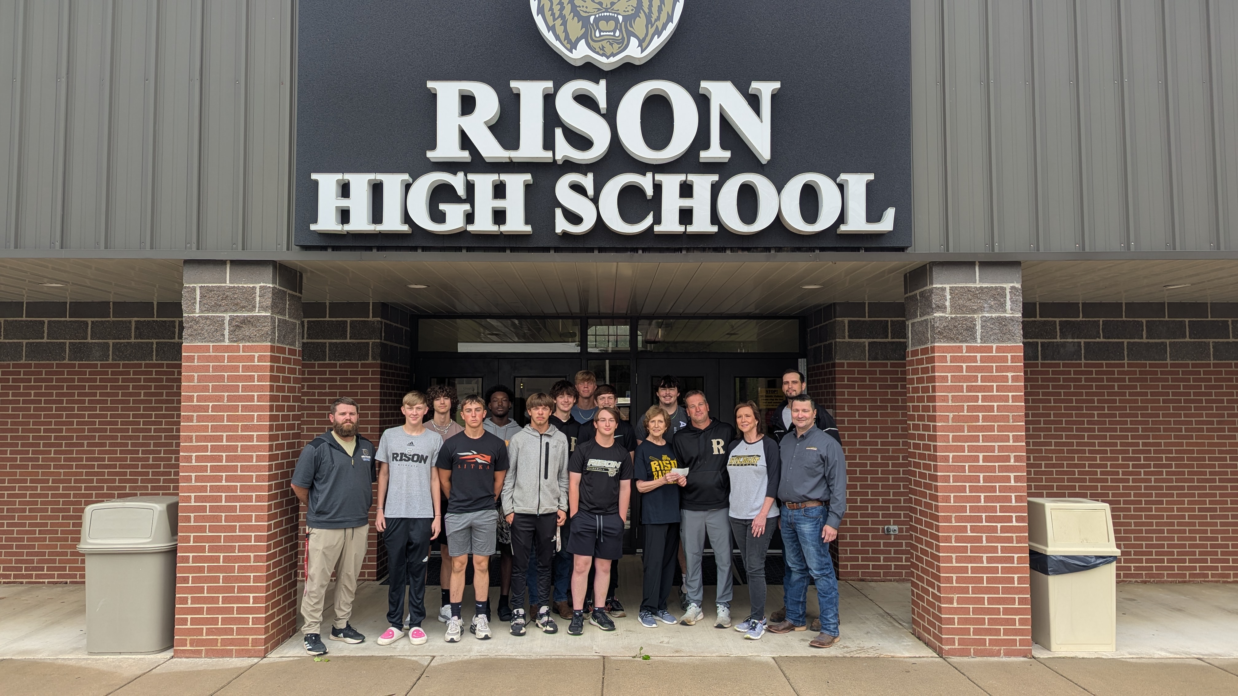 Pictured alongside a portion of the baseball team are coaches Chad Cope and Kyle Thaxton, Nora Terry, Kristy Lowery, Keden Shrum and Cordero Fuentes. 