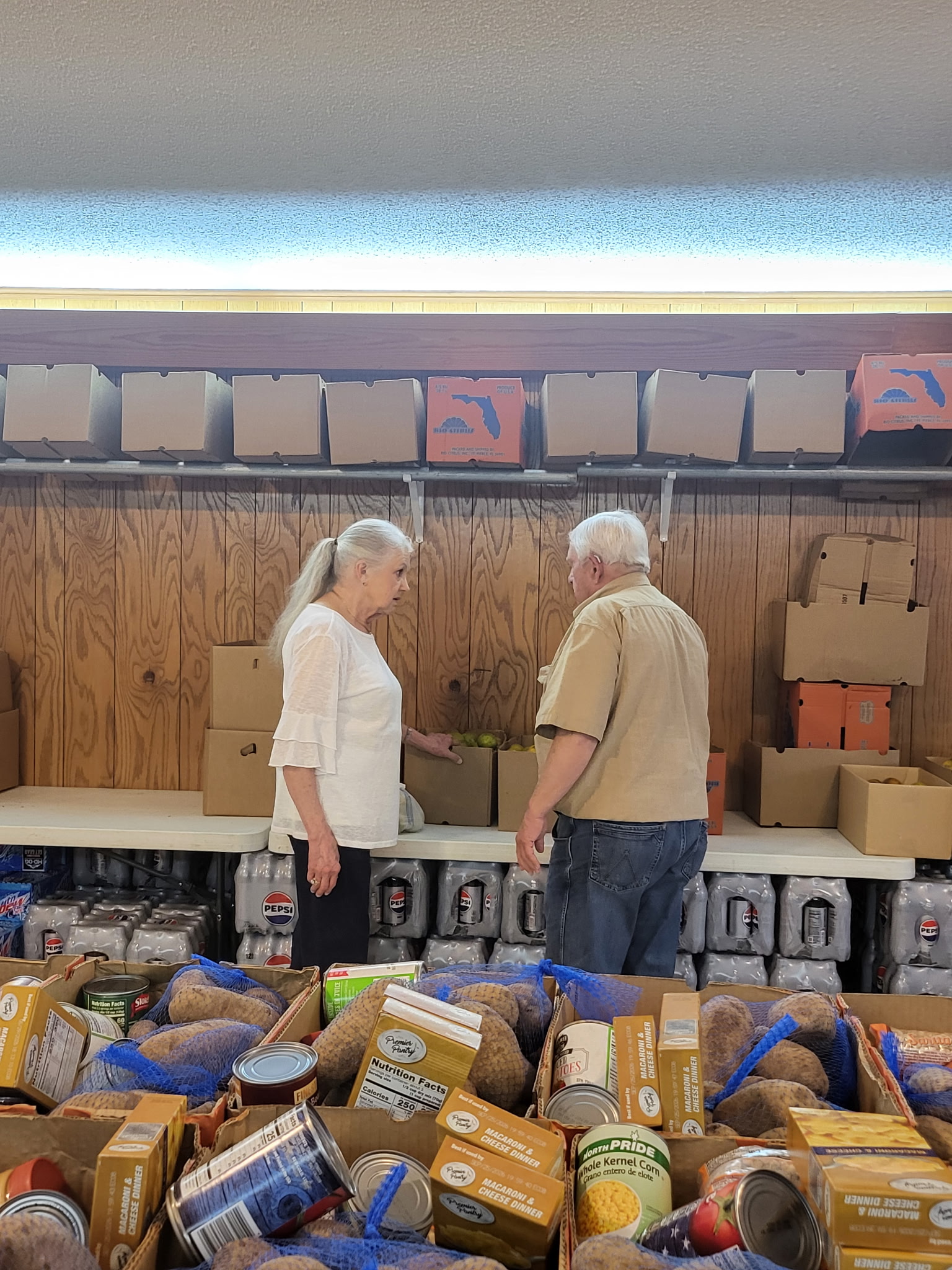 STOCKING THE PANTRY - Pam Martin (left) and Charles Rodgers (right) are two of dozens of volunteers who assist with the Rison United Methodist Church Food Pantry. To help stock the pantry, which serves over 100 families each month, the church is hosting a Dorey’s Catfish dinner Thursday, May 8. (Photo courtesy Barbara Cox)