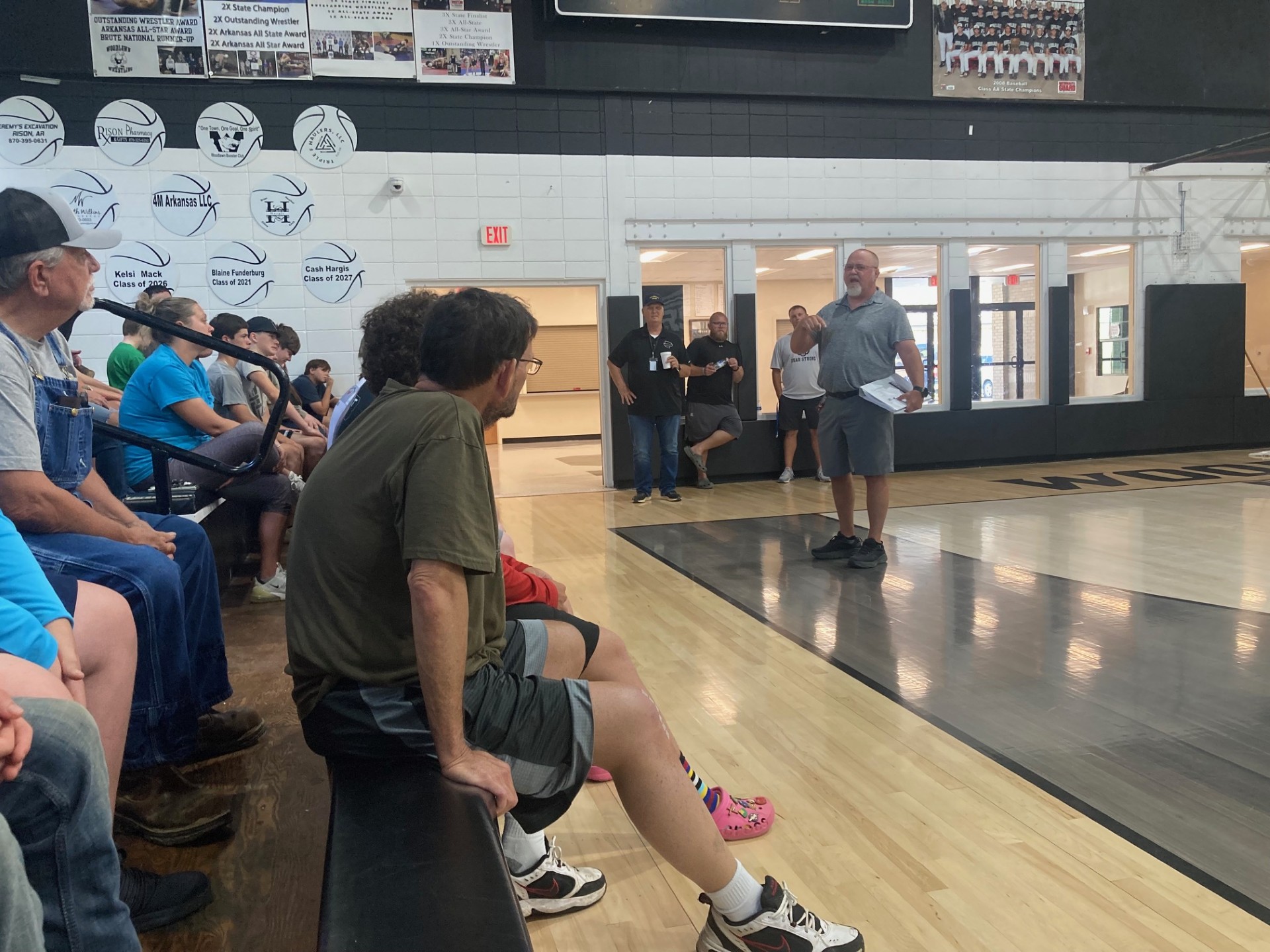 MEANS VISITS PLAYERS - New Woodlawn Football Coach Doug Means (right) speaks with players and parents during his first meeting with his new team last Friday afternoon at the Woodlawn Gym. Means brings plenty of experience coaching both offense and defense, mostly at larger schools in Georgia,Florida and Arkansas. Pictured in the background are (left to right) Woodlawn Superintendent Dr. Kevin Hancock and assistant football coaches Michael Anderson and Matt Huitt.