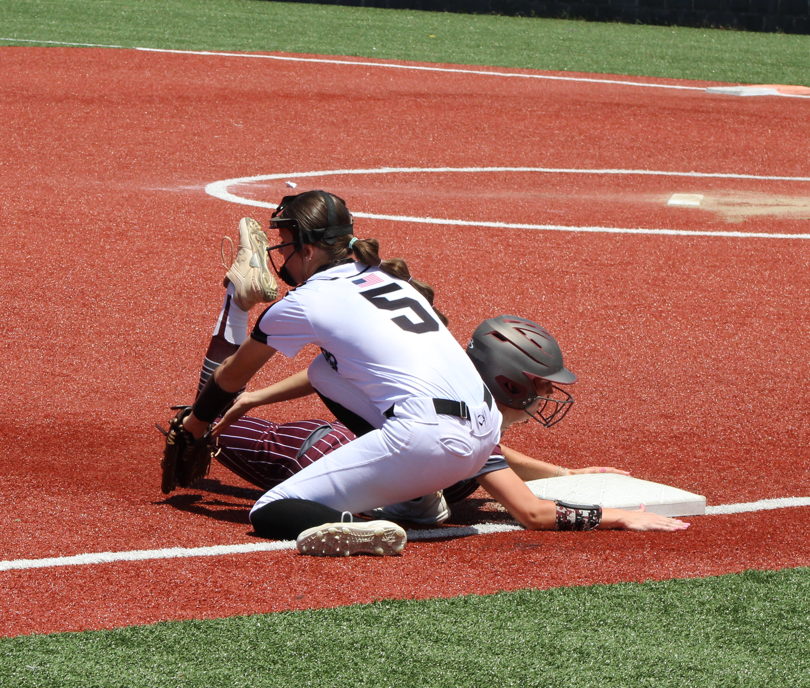 CRITICAL PLAY - Riverside’s Carly Jo Womack beats out the tag from Woodlawn’s Kathryn Dixon at third base in a critical play in the top of the fifth. Her slow-rolling liner into left gave her enough time to squeeze out a triple, eventually scoring the game’s only run on a passed ball with two out. 