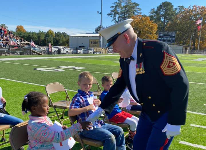 Retired Sgt. Major Jimmy Cummings (U.S. Marines) shakes hands with students at Rison Elementary. (Photo Courtesy Cummings Family)