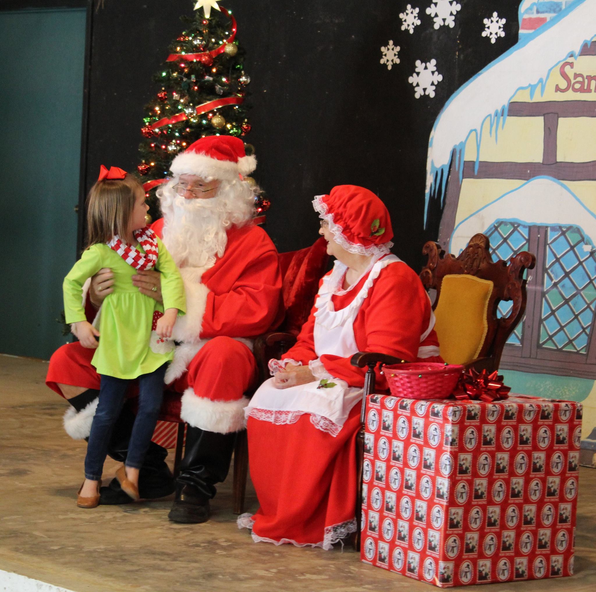 CHRISTMAS IN THE VILLAGE - In this photo from 2017, a young child visits with Santa and Mrs. Claus at the Christmas in the Village Festival at the Pioneer Village. This year’s festival will be held over two nights, Dec. 4 and Dec. 11.