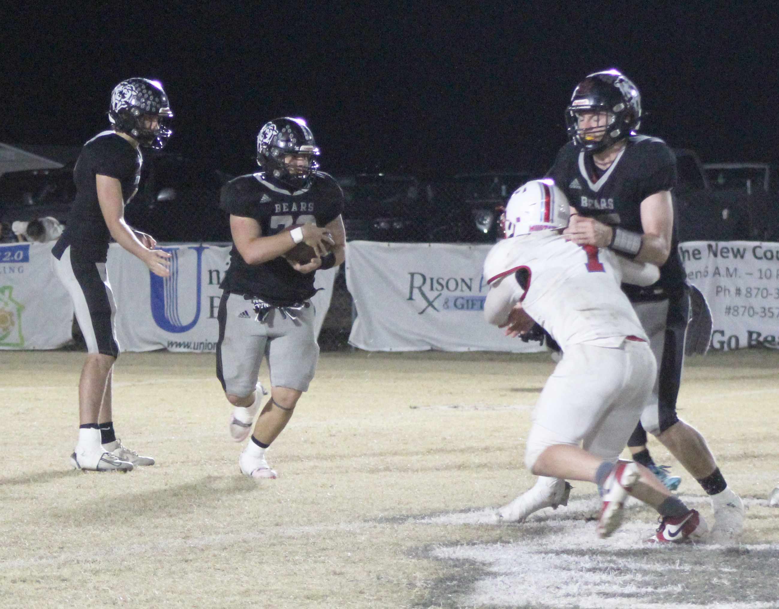 BIG GAME FOR CULLIFORD - Woodlawn running back Ace Culliford (second from left) take as handoff from quarterback Ethan Saeler while tight end Beau Watson (right) sets a block. With Saeler off limits for the run game in the second half, Culliford proved valuable down the stretch as he churned out 54 yards on eight carries to help the Bears hold onto the ball and melt the clock in the fourth quarter.