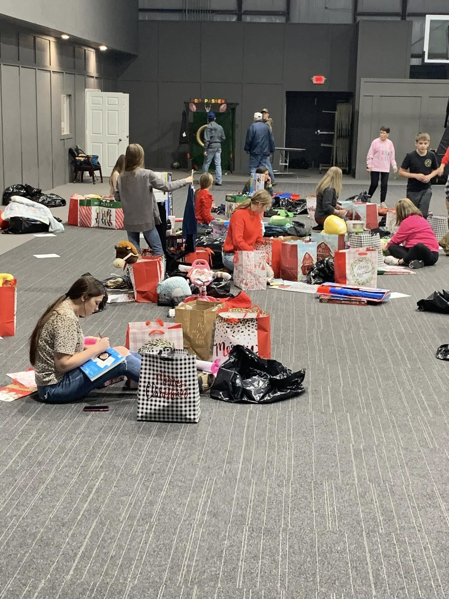 PACKING GIFTS - Cleveland County Cares volunteers are pictured packing up Christmas gifts during last year’s holiday season. The organization is accepting funds to purchase gifts and essentials for families in need this year.
