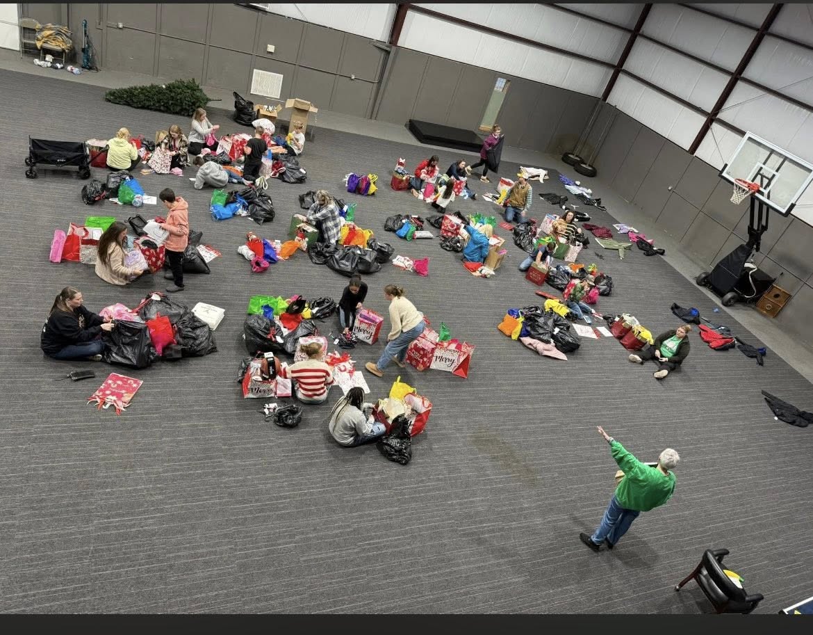 CLEVELAND COUNTY CARES BREAKS RECORD - Melinda McKnight (bottom right corner) oversees the packaging of gifts at Rison Baptist Church over the weekend as the organization prepares to deliver to families for Christmas. This year the Cleveland County Cares organization reached a record number of kids receiving gifts this year, 99.