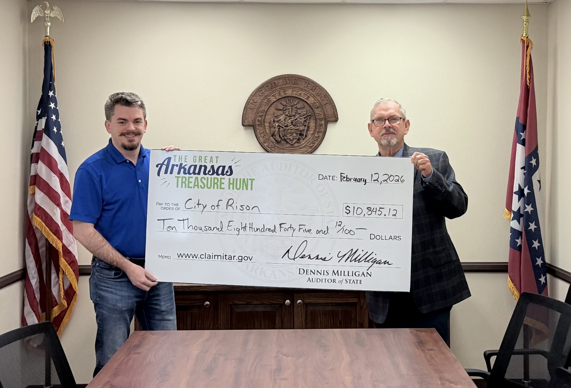 CITY OF RISON FINDS ITS OWN TREASURER - Thomas Burchfield (left) of the State Auditor’s office presents Rison Mayor Charles Roberts (right) with a check for $10,845.12. Roberts said he discovered the city had the unclaimed money while visiting the State Auditor’s booth at the Arkansas Municipal League meeting in Hot Springs over the weekend.
