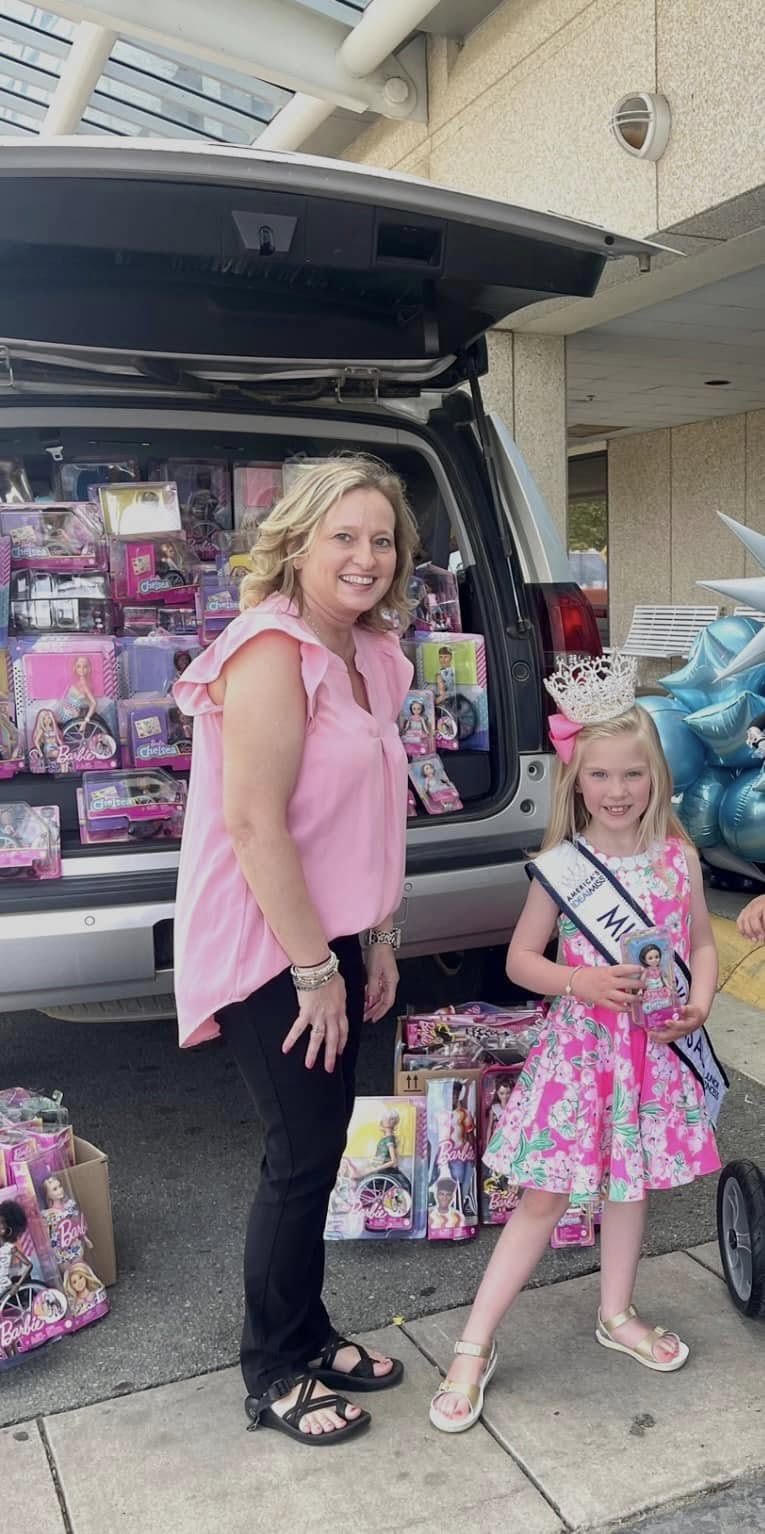 JUST LIKE ME - Stacy Walz (left) and Nancy Lawson (right) deliver handicapped Barbies to Arkansas Children’s Hospital in a previous drive on their Just Like Me platform.