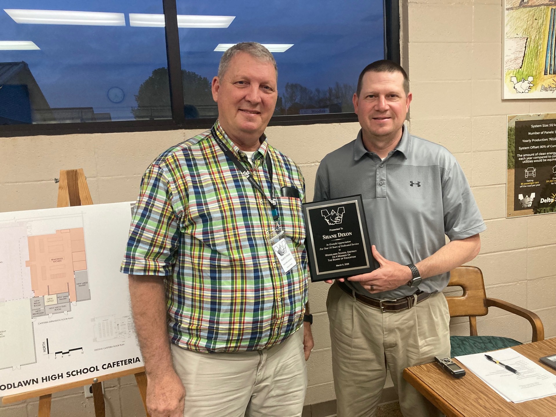 Woodlawn Superintendent Dr. Kevin Hancock (left) presented outgoing Woodlawn School Board President Shane Dixon with a plaque recognizing his 10 years of service on the school.