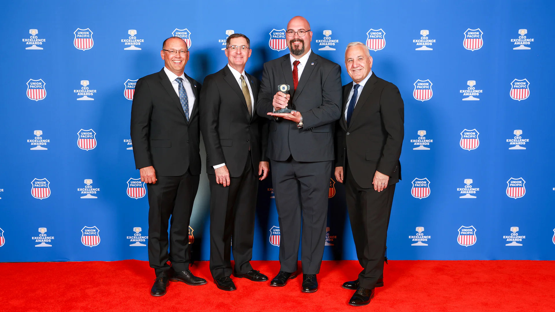 From left: Steven Bybee, senior vice president-Operations; Rod Doerr, vice president and chief safety officer; John Varnell, locomotive engineer; and Jim Vena, CEO.
