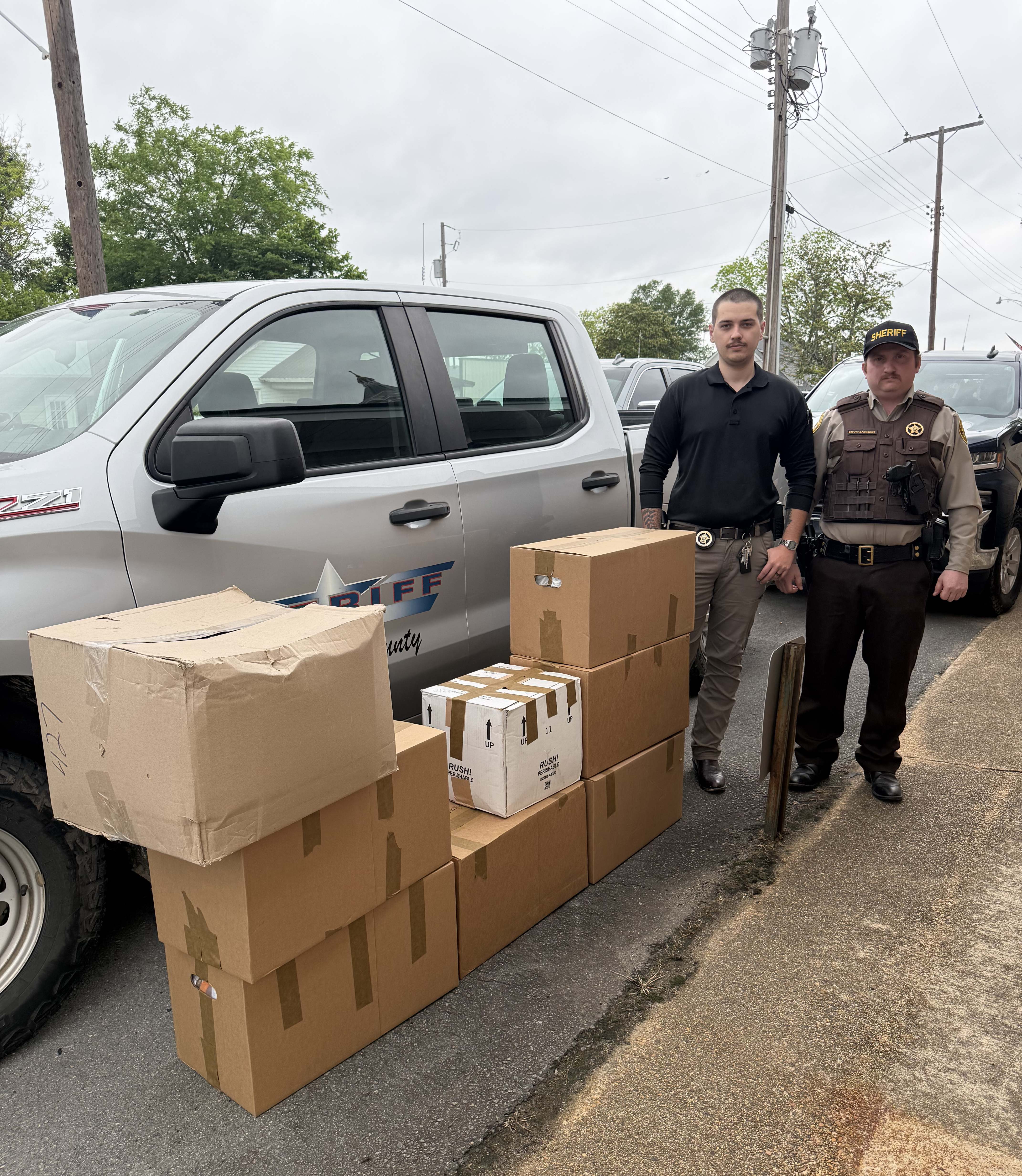 Pictured are Cleveland County Sheriff’s Department investigator Jakeb Croy and Deputy Stewart “Pic” Pickering with eight boxes of unused medications collected from within the county. (Photo compliments of Cleveland County Sheriff’s Department)
