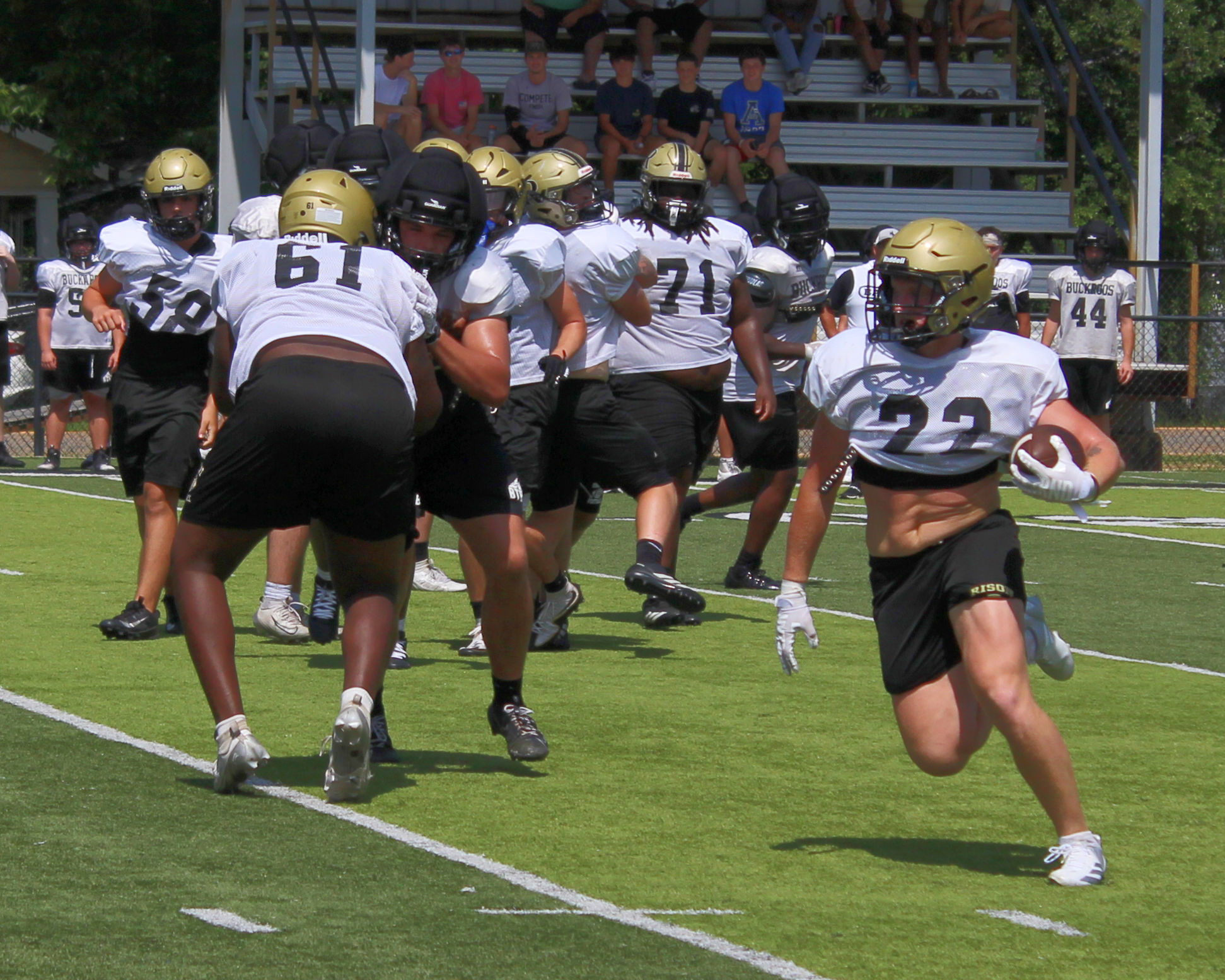 FINAL SUMMER CAMP FOR WILDCATS - Aidan Bitely (no. 22) follows the block of Dedrick Wells (no. 61) for a nice gain against the Smackover Buckaroos during Tuesday’s football camp hosted by Rison at George Walker Field of Champions. Bitely, a transfer from White Hall, is one of the new skill players that will be lining up for the Wildcats this season as Coach Chris Vereen looks to diversify the offense.