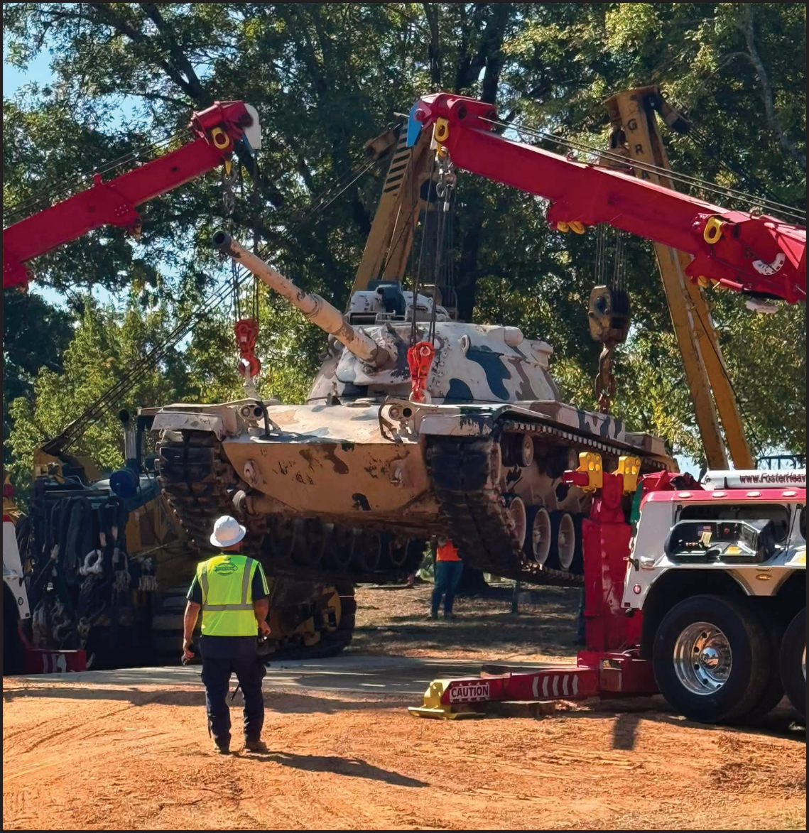 SETTLING INTO ITS NEW HOME - Cranes from Foster Towing of Pine Bluff and Grace Railroad Contractors of Star City lower the 50-plus ton M60 tank into place at Veterans Park in Rison Saturday morning. The tank was previously on display at Hamburg. (Photo compliments of Brad Young)