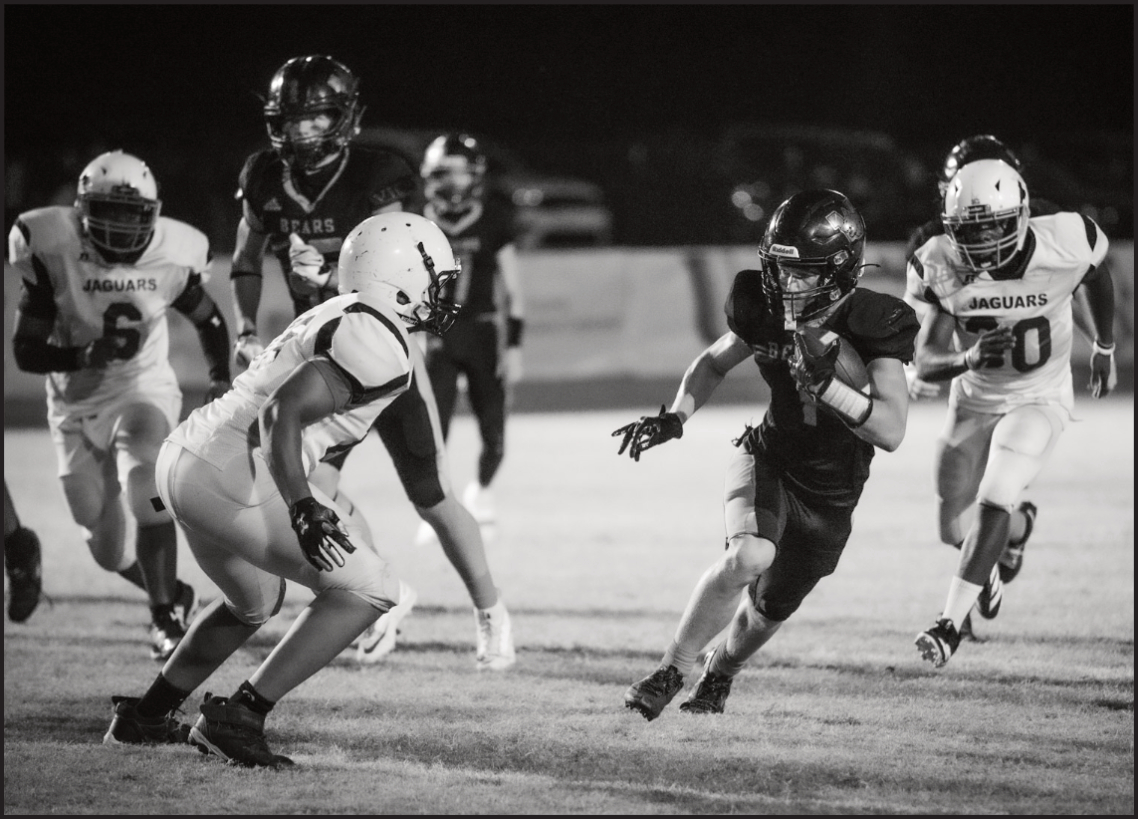 CAREER NIGHT FOR MANES - Woodlawn’s junior running Griffin Manes looks to get outside a Friendship Aspire defender during the Bears’ 52-14 homecoming victory over the Jaguars Friday night at the Carl Jones Sports Complex. Manes rushed for 308 yards on 16 carries with five touchdowns.  (Photo by Kelvin Scott of Cardboard Sports)