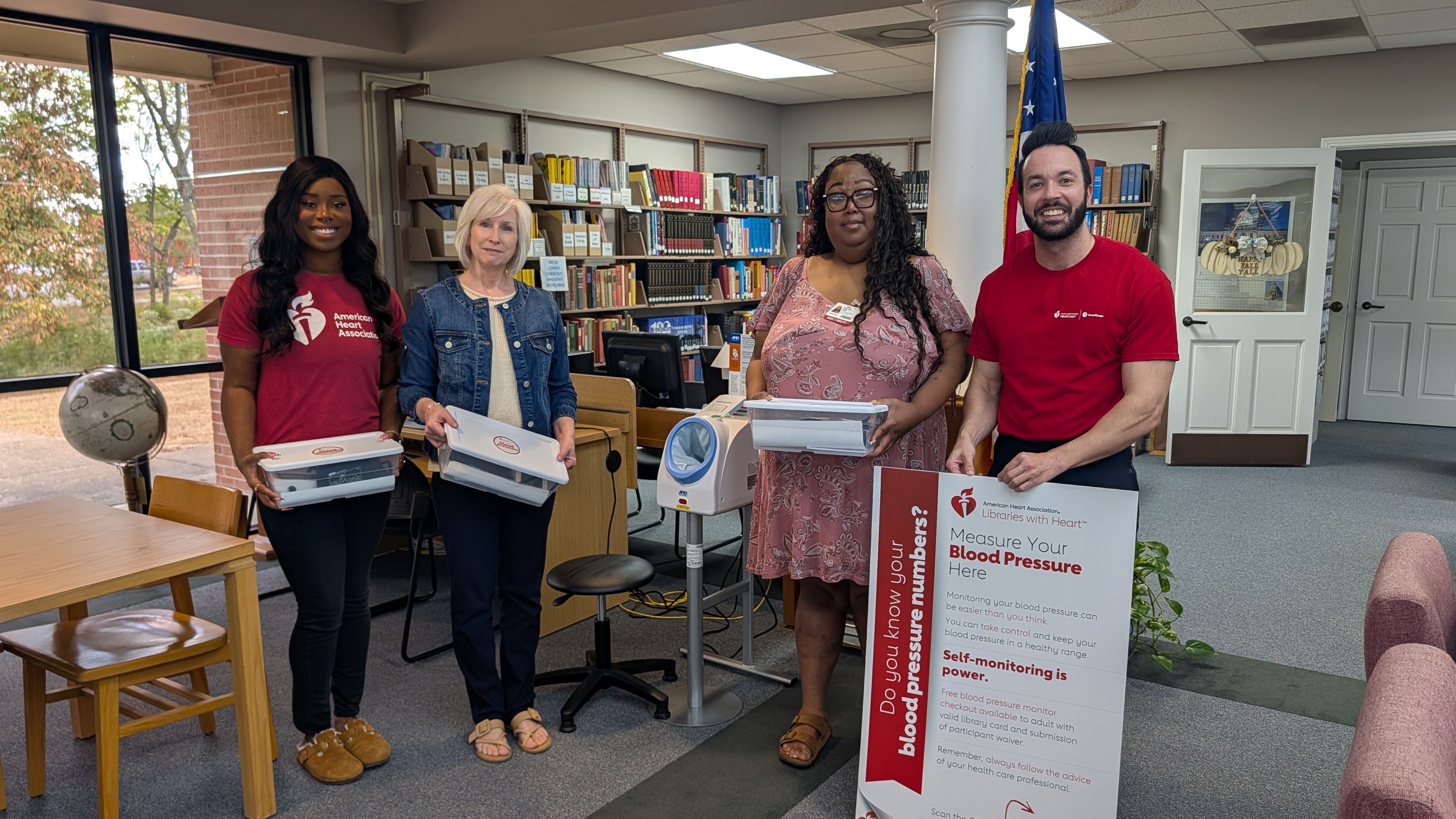 Pictured left to right are Jamya Pinkney-Delaumel, Community Connector for the American Heart Association, Librarian Hilda Terry, Rachel Will, Outreach Coordinator for UAMS, and Brady Lacy, Senior Community Impact Director.