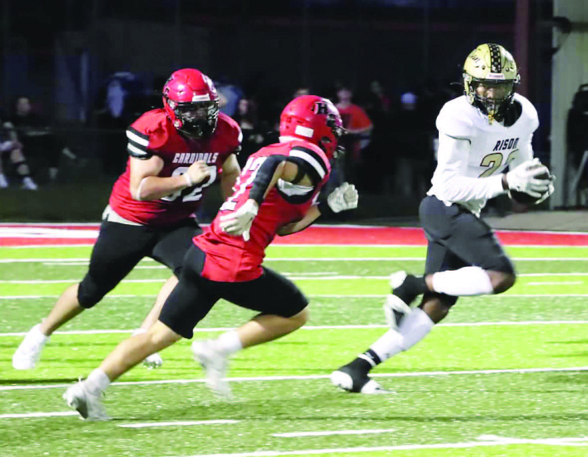 BREAKING LOOSE - Rison running back Christian Reeves (right) eludes a couple of Harmony Grovbe defenders before racing 78 yards for a touchdown to give the Wildcats a 28-7 lead in the second quarter. Reeves finished the game with 144 yards on 10 carries. (Photo by Chris Phillips)