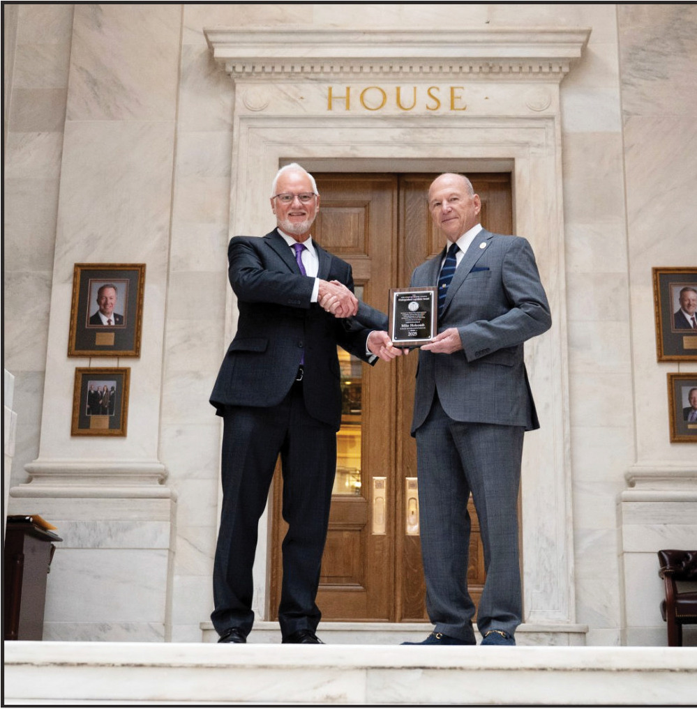 MUNICIPAL LEAGUE RECOGNIZES HOLCOMB - The Arkansas Municipal League has presented District 93 State Rep. Mike Holcomb with the Distinguished Legislator Award in recognition of his work during the 2025 Regular Session. Holcomb's district includes a section of northern and eastern Cleveland County. Pictured are Jack Critcher (left), legislative liaison for the Arkansas Municipal League, and State Rep. Mike Holcomb (right).