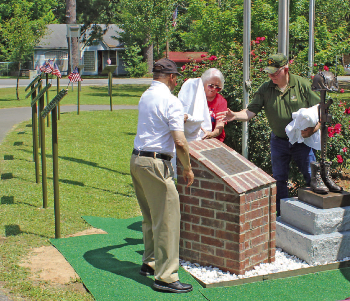 DANNY JACKS MEMORIAL STATUE UNVEILING - Col. Ralph Tildon, retired U.S. Army Reserves, (left) and Mrs. Marcel Jacks (center), wife of the late Staff Sgt. Danny Lee Jacks of Rowell, unveiled a statue and plaque that were erected in Jacks' honor at the Cleveland County Veterans Park in Rison Saturday morning. Tildon served as an executive officer in the same Army company as Staff Sgt. Jacks in Vietnam. The two became close friends in annual reunions that the company held after the