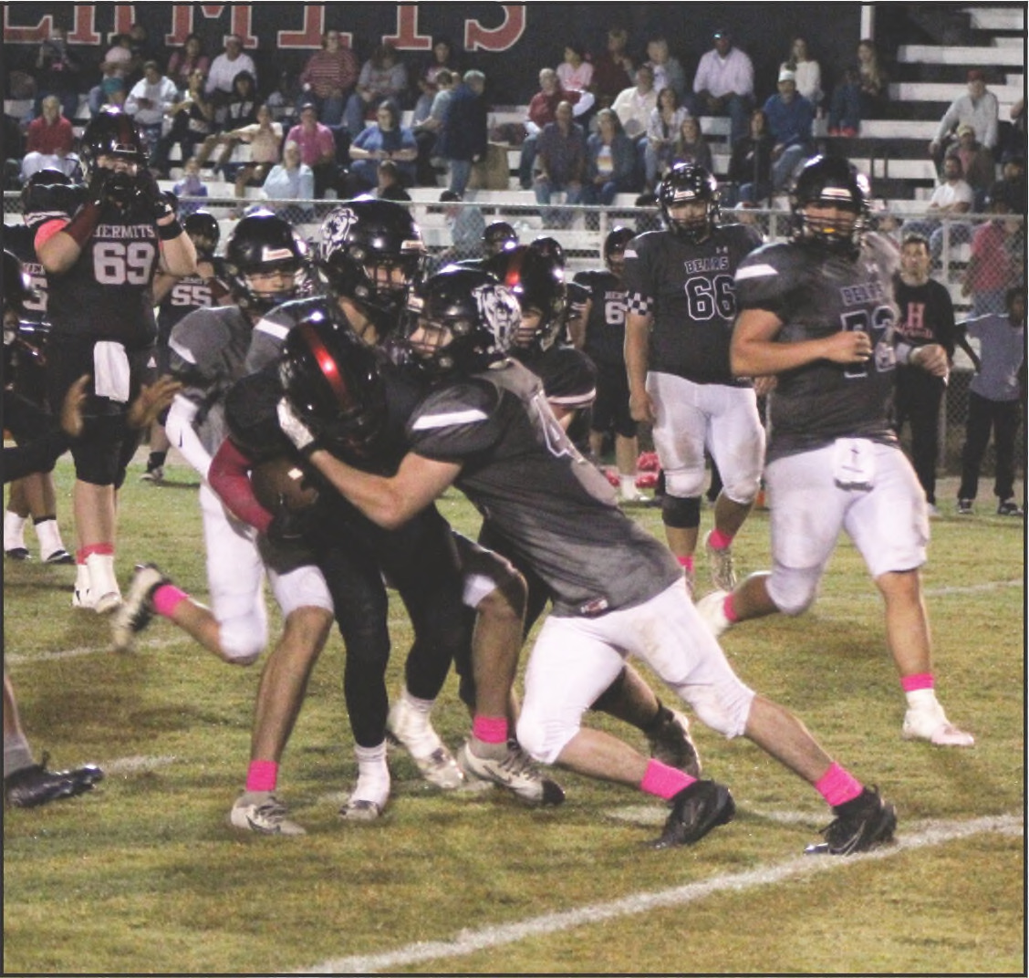 HAMMERING THE HERMITS - Woodlawn’s Matthew Green (foreground, 40) and Ethan Saeler bring down a Hermit during the Bears’ 70-20 rout Friday night at Hermitage. Green finished the game with 10 tackles (five solo), three tackles for losses, a sack, a force fumble and two third-down stops. He also recovered two onside kicks. Woodlawn held Hermitage to 21 yards rushingforthe game. Also pictured forthe Bears are Brayden Jones (behind Saeler), Dakota Campbell (66) and Ace Culliford (72).