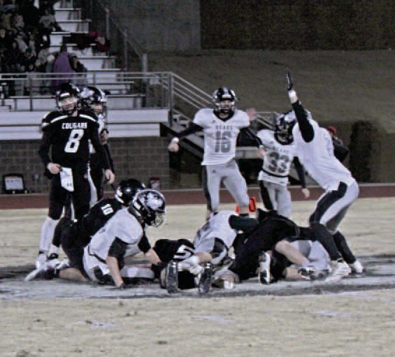 ONSIDE KICK RECOVERY - Woodlawn (white) and Izard County (black) players react after the Bears' Payton Leveritt (on the ground, right) came up with a onside kick recovery that enabled the Bears to erase a 16-point fourth quarter and tie the game, 56-56, with 2:24 left. Pictured for Woodlawn are (on ground, left to right) Landen Booth, Matthew Vontungeln and Leveritt; (standing, left to right) Ethan Oliver (no. 16), Aidan Moore (no. 33) and Jaxson Raney (no. 24).