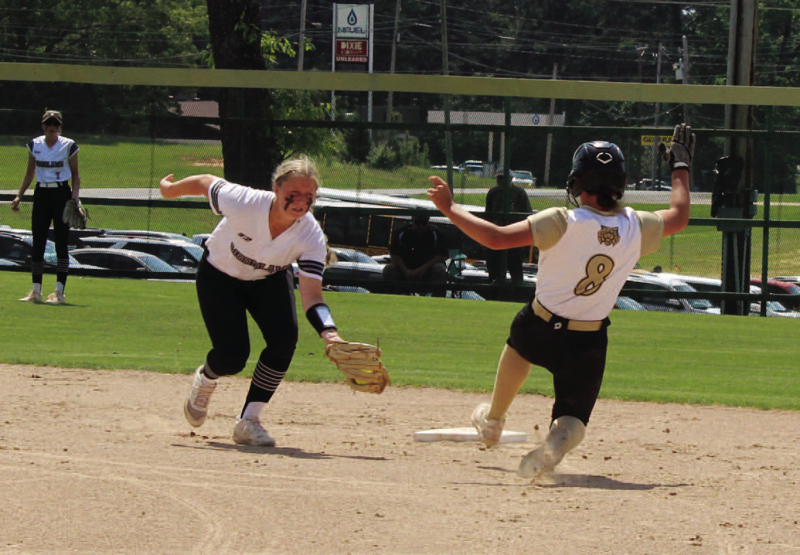 STEALING SECOND - Rison's Layne Potter (right) begins her slide beneath the tag of Woodlawn's Kendall Tooke (left) during first inning action of Saturday's Clas 2A South Region championship game. Potter went on to score what would be the first of five runs for the Lady Wildcats in the opening frame.