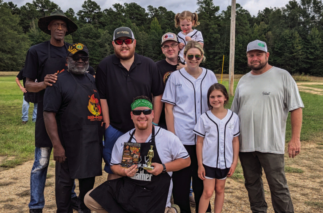 PEOPLE'S CHOICE CONTEST ($175 PRIZE) - Devin Herron (center) an d his Senor Winkey's Team won first place in the People's Choice Contest. Also pictured are Penny Morris' Bar-B-Crew (left) in third place, and Travis McDaniels's Outcast BBQ (right) in second place.