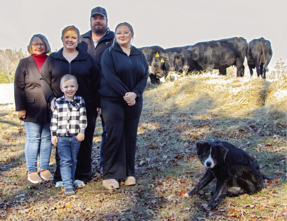 FARM FAMILY OF THE YEAR - Jason and Ashley Boyd (center) of Ris on were named the Cleveland County Farm Family of the Year 2024. The couple are pictured with two of their children Taylor (right) and Wyatt (front), Jason's mother, Pat (far left). Daughter Haley is not pictured. The family's dog Festus joined them for a photo after herding the cows.